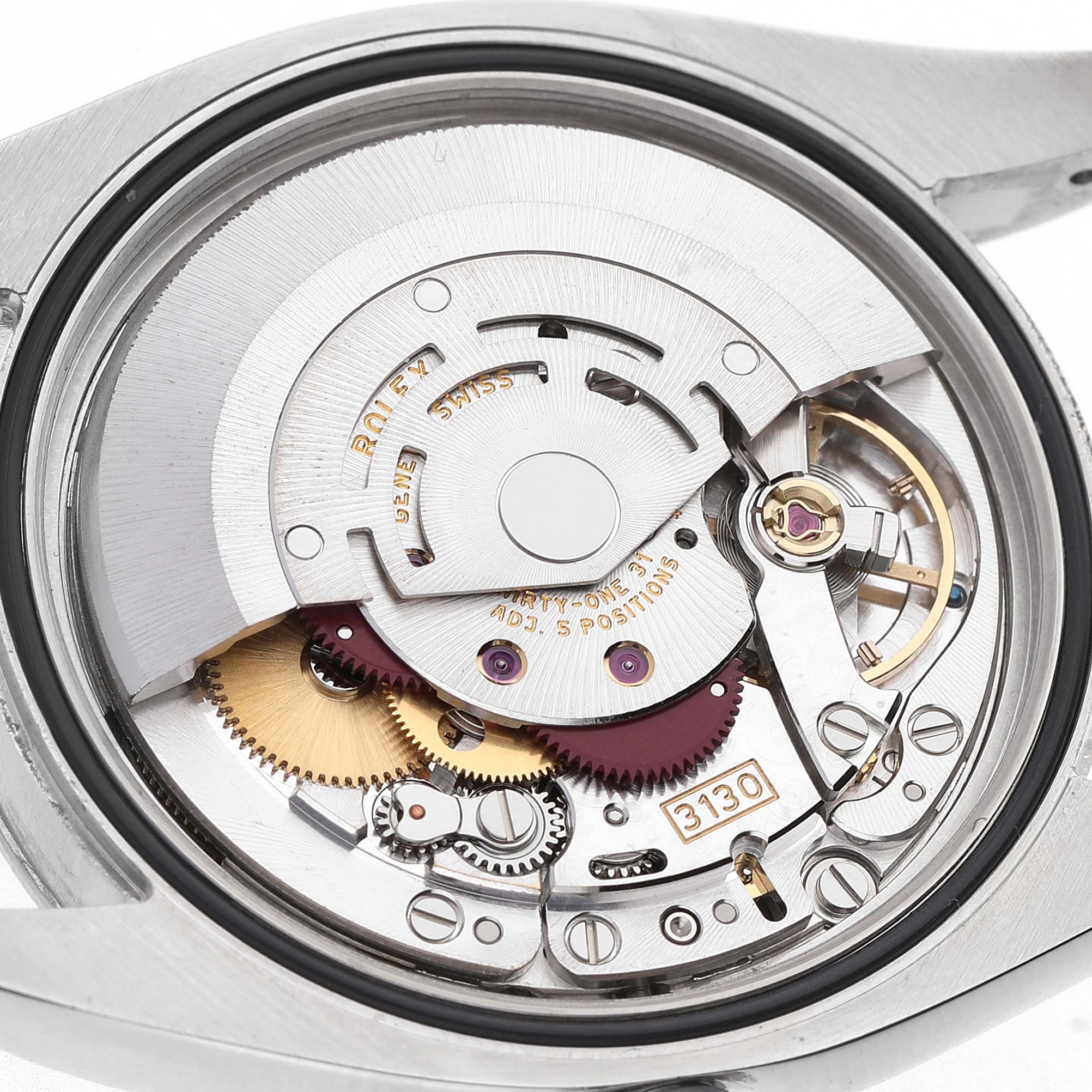 The image shows the intricate movement of a Rolex Oyster Perpetual 116034 Men's Stainless Steel Black Dial watch, viewed from the back, revealing gears and components.