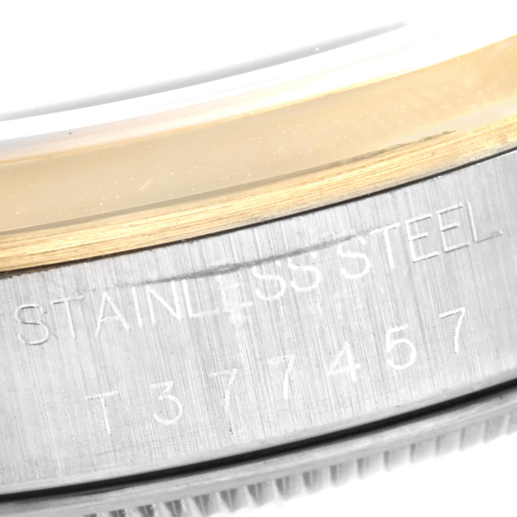 This image shows a close-up view of the case side and the engravings on a Rolex Oyster Perpetual 14203 Men's Steel and Gold (two tone) Grey Dial 14203 Men's Steel and Gold (two tone) Grey Dial watch.