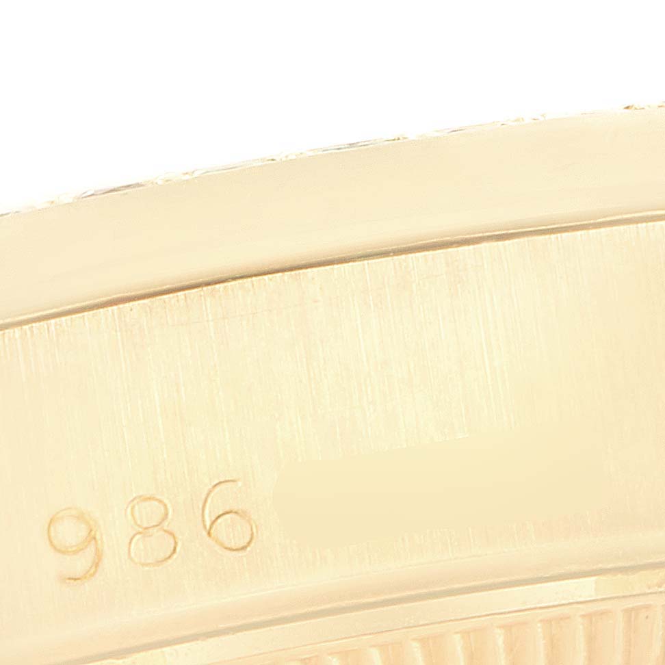 This image shows a close-up of the side of the bezel on a Rolex President 69038 Women's Yellow Gold Champagne Dial 69038 Women's Yellow Gold Champagne Dial model watch, displaying a partial serial number.