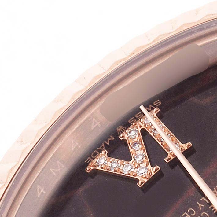 The image shows a close-up of the dial and bezel of a Rolex President 128235 Men's Rose Gold Brown Dial watch with jeweled markers.