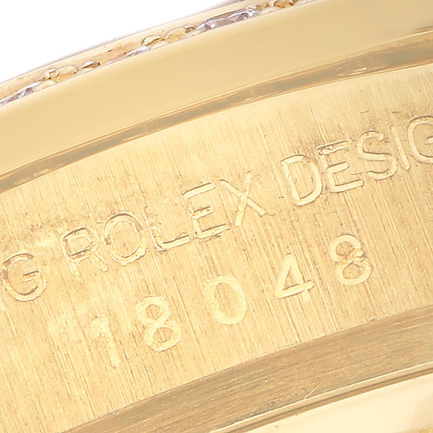The image shows a close-up of the engraved inner case of a Rolex President 18048 Men's Yellow Gold Champagne Dial 18048 Men's Yellow Gold Champagne Dial model, highlighting the design and reference number.