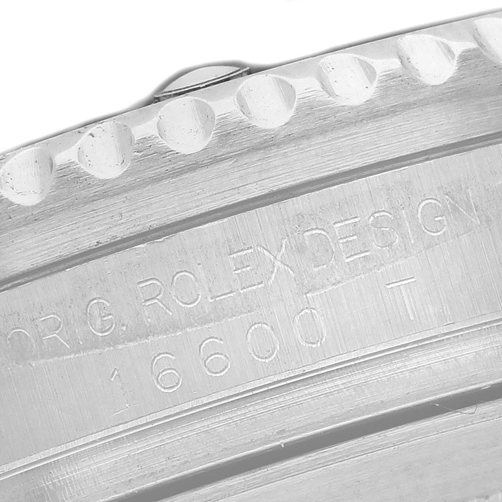 The image shows a close-up of the case side and bezel edge of the Rolex Sea-Dweller M16600T Men's Stainless Steel Black Dial with model number engraving.