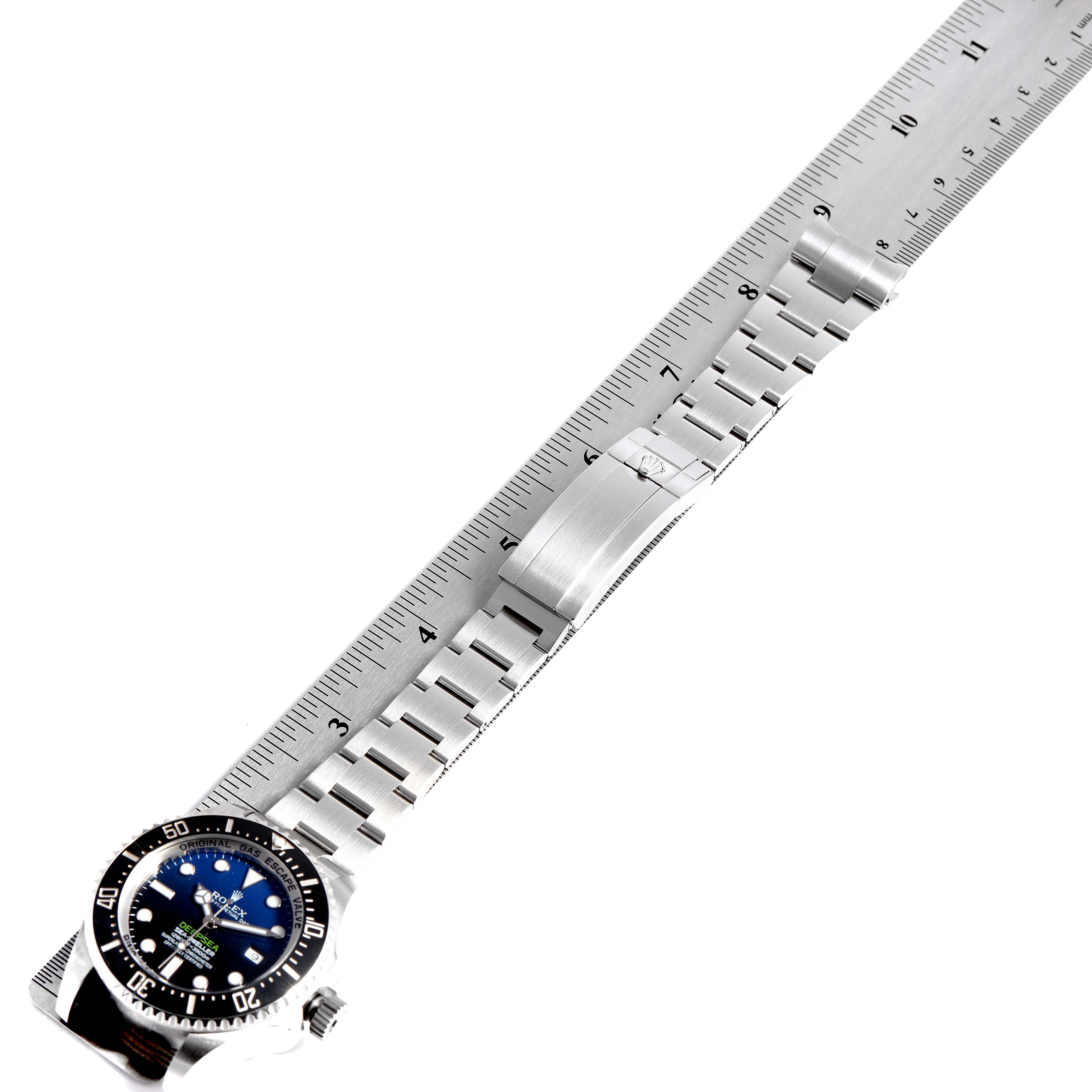 The image shows a Rolex Sea-Dweller 116660 Men
s Stainless Steel Blue Dial 116660 Men
s Stainless Steel Blue Dial watch, featuring its face, bracelet, and clasp aligned with a ruler.