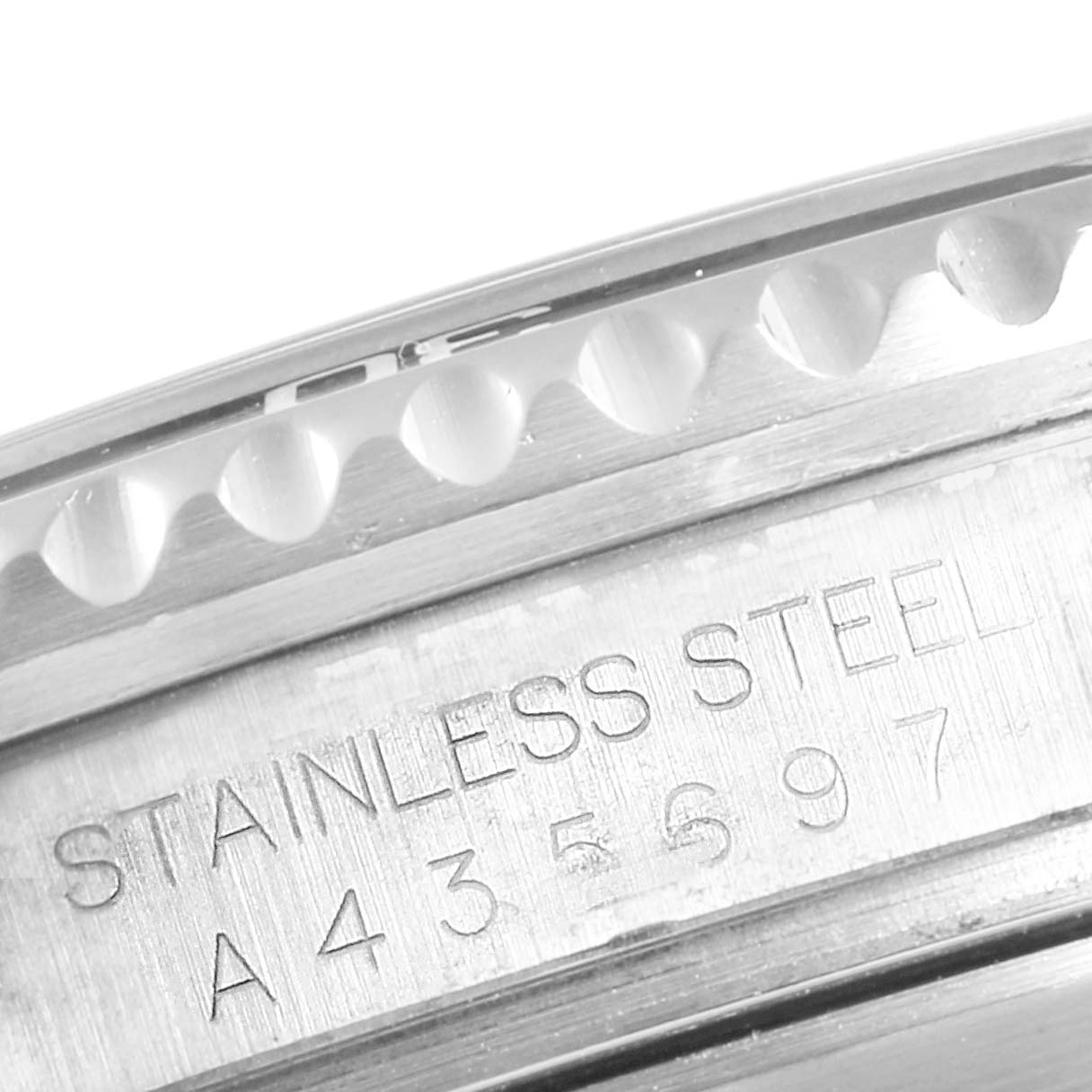 The image shows a close-up of the engraved serial and material details on the side of a stainless steel Rolex Submariner 16610 Men
s Stainless Steel Black Dial 16610 Men
s Stainless Steel Black Dial watch case.