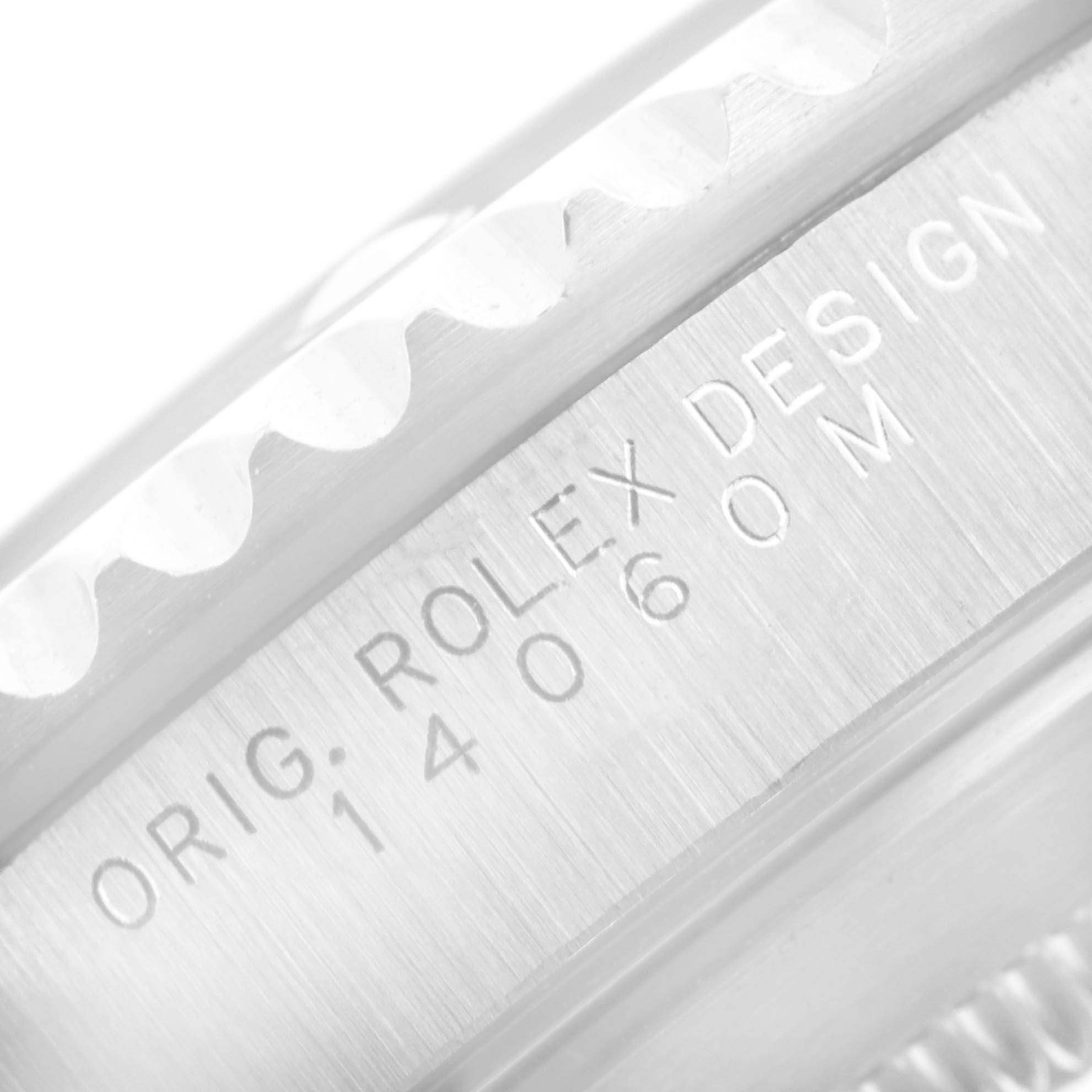 This close-up angle shows the bezel and part of the case of a Rolex Submariner 14060 Men's Stainless Steel Black Dial 14060 Men's Stainless Steel Black Dial with the model number 14060M engraved.