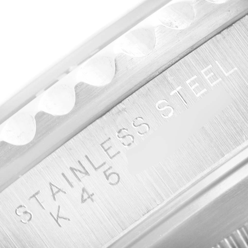 This close-up image shows the engraved "STAINLESS STEEL" text on the side of the bezel of a Rolex Submariner 14060 Men's Stainless Steel Black Dial 14060 Men's Stainless Steel Black Dial watch.