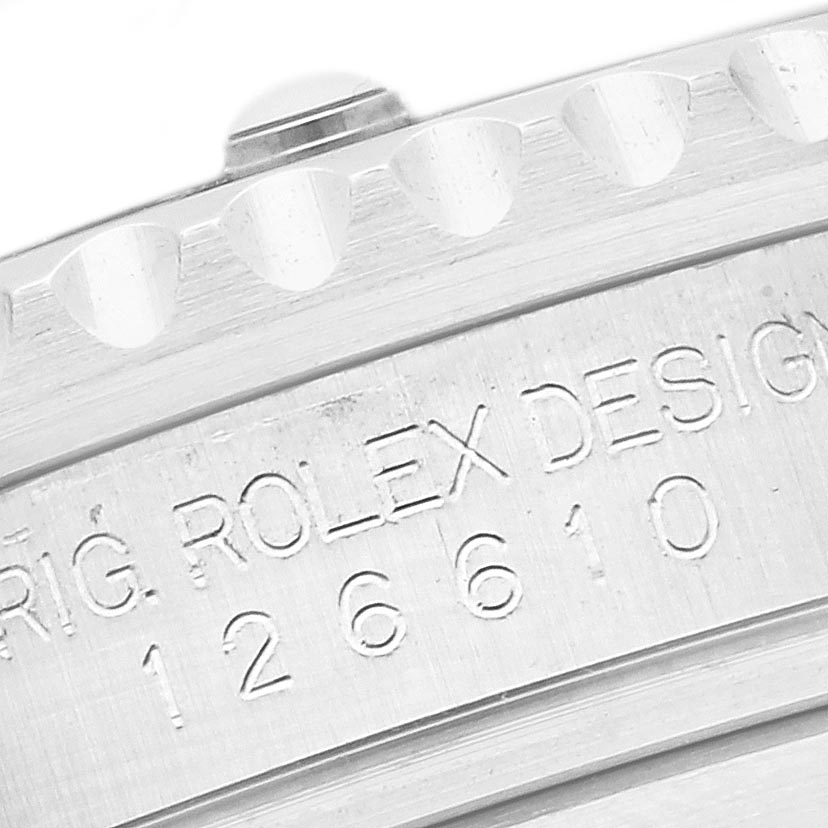 The image shows a close-up of the Rolex Submariner 126610LN Men's Stainless Steel Black Dial 126610LN Men's Stainless Steel Black Dial's case back, highlighting engraved text and part of the bezel edge.