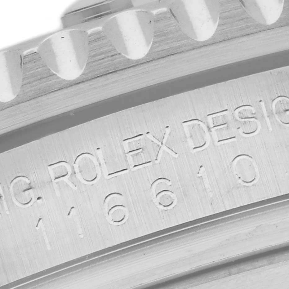 This image shows a close-up of the case back engraving of a Rolex Submariner 116610LN Men
s Stainless Steel Black Dial 116610LN Men
s Stainless Steel Black Dial, including part of the bezel.