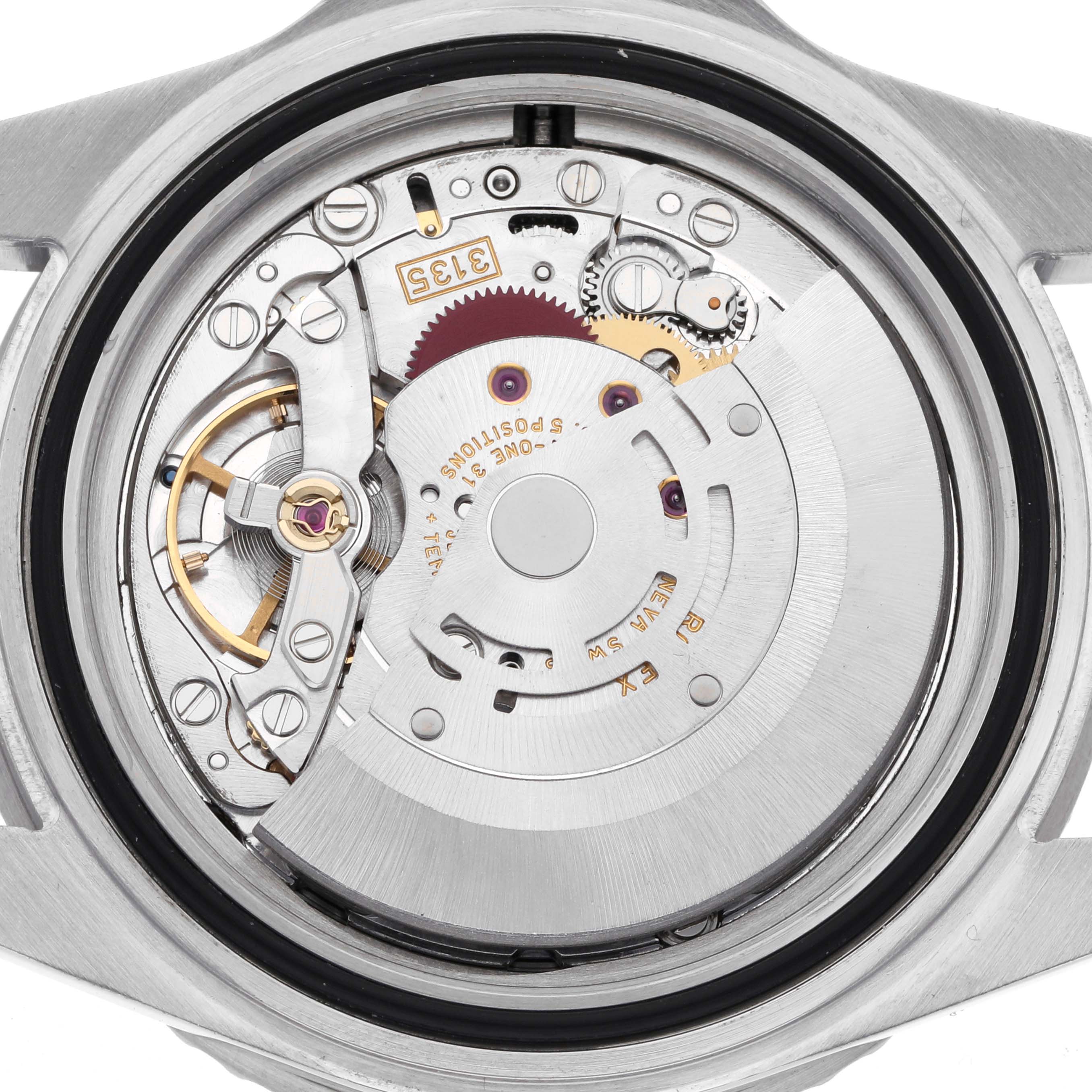 The image shows the movement of a Rolex Submariner 16610 Men's Stainless Steel Black Dial 16610 Men's Stainless Steel Black Dial from a back view, highlighting gears and mechanical components.