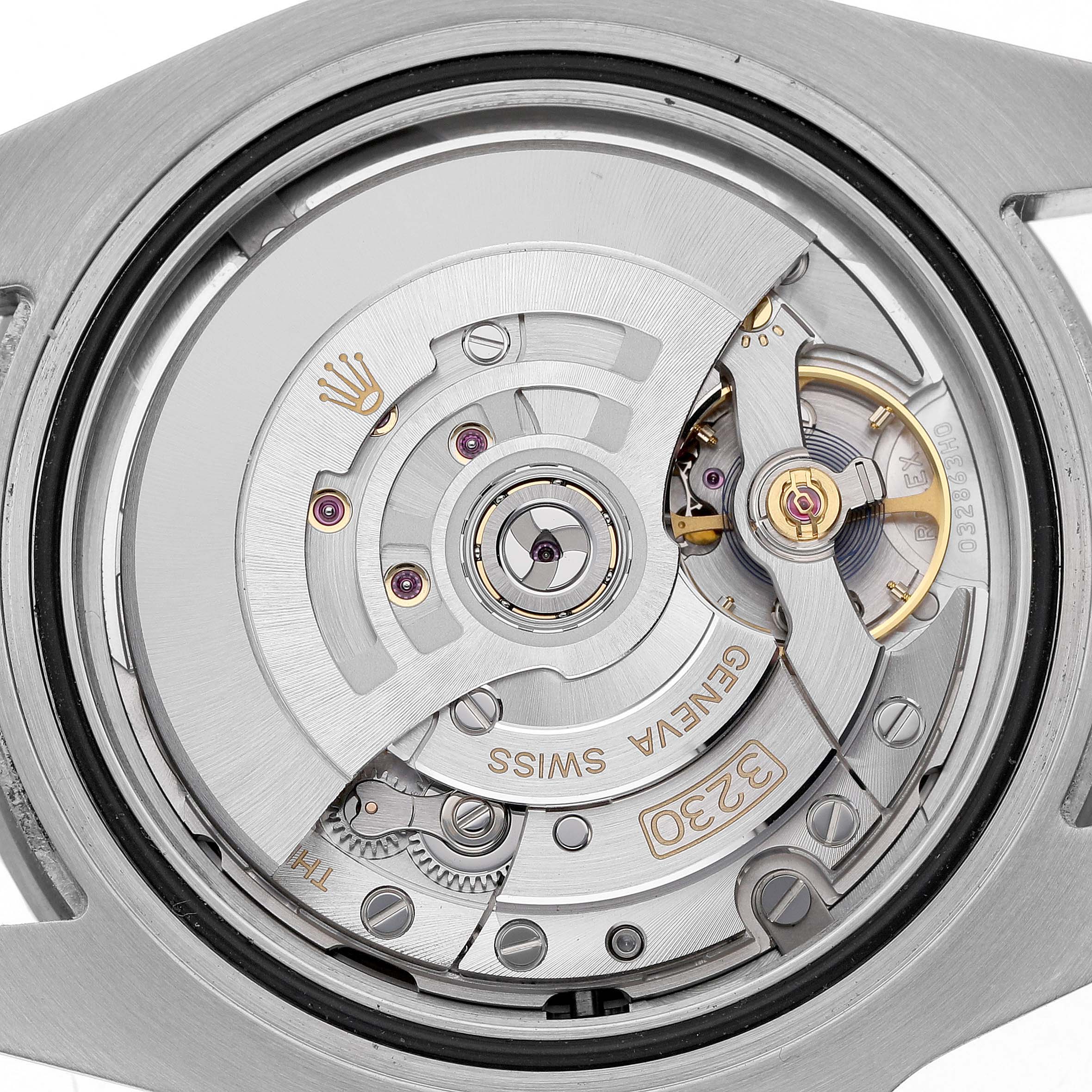 The image shows a close-up of the movement mechanism of a Rolex Submariner M124060-0001 Men's Stainless Steel Black Dial, displaying gears and the rotor.