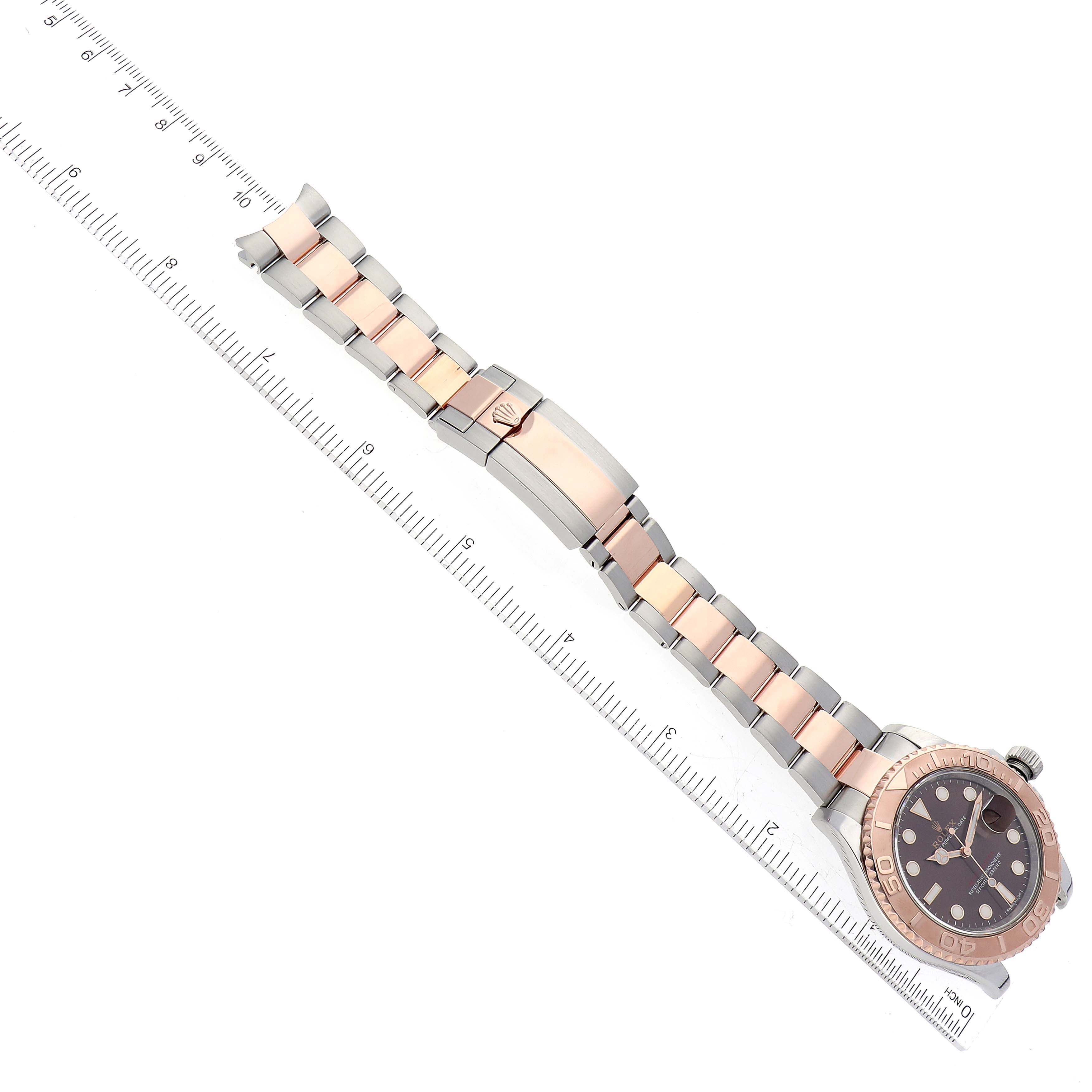 The Rolex Yacht-Master 116621 Men's Steel and Gold (two tone) Brown Dial 116621 Men's Steel and Gold (two tone) Brown Dial watch is shown from a top-down angle, displaying its face, bezel, and bracelet with clasp.