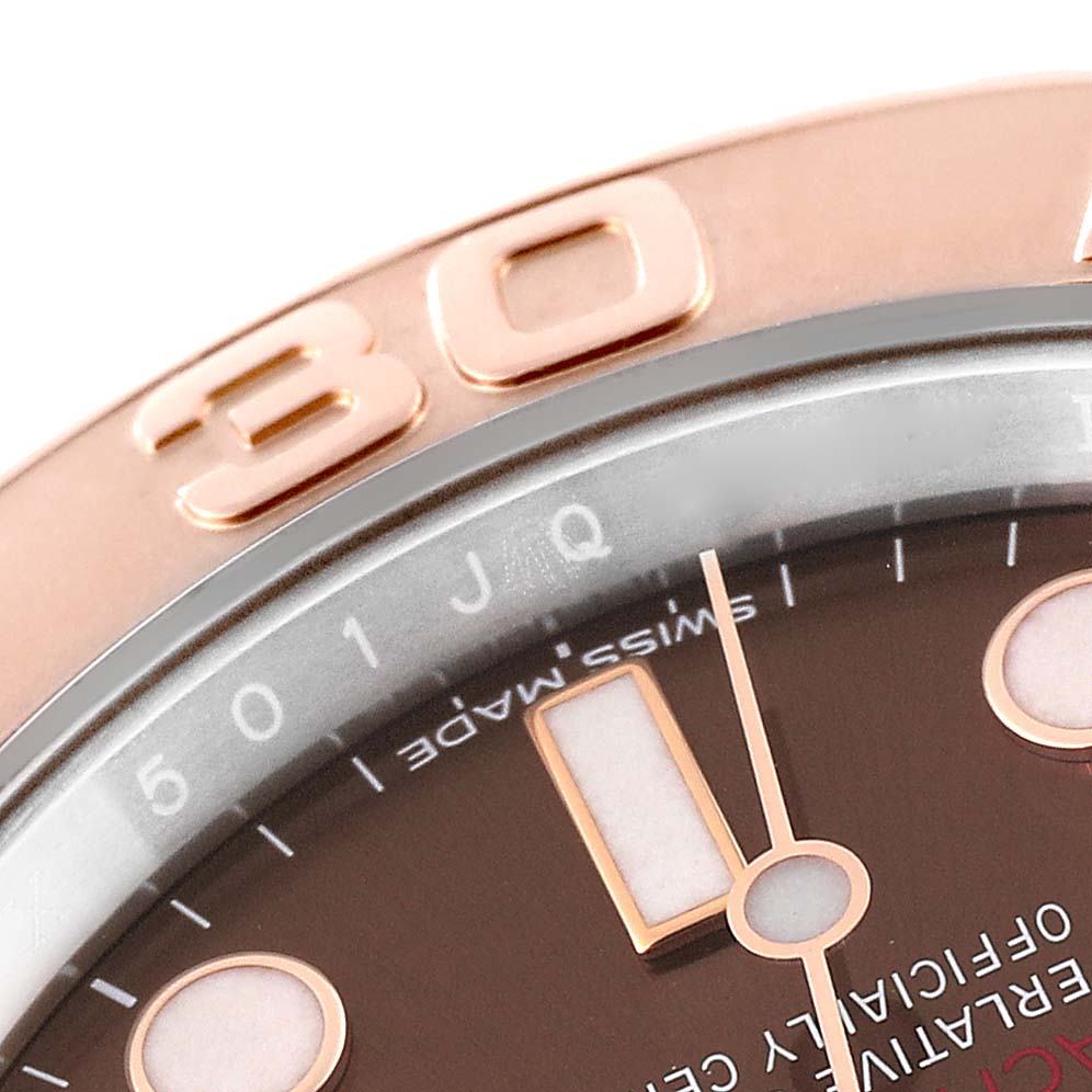 This close-up image of a Rolex Yacht-Master 116621 Men's Steel and Gold (two tone) Brown Dial 116621 Men's Steel and Gold (two tone) Brown Dial watch shows the bezel with "30" engraving, part of the dial, hour markers, and hands.