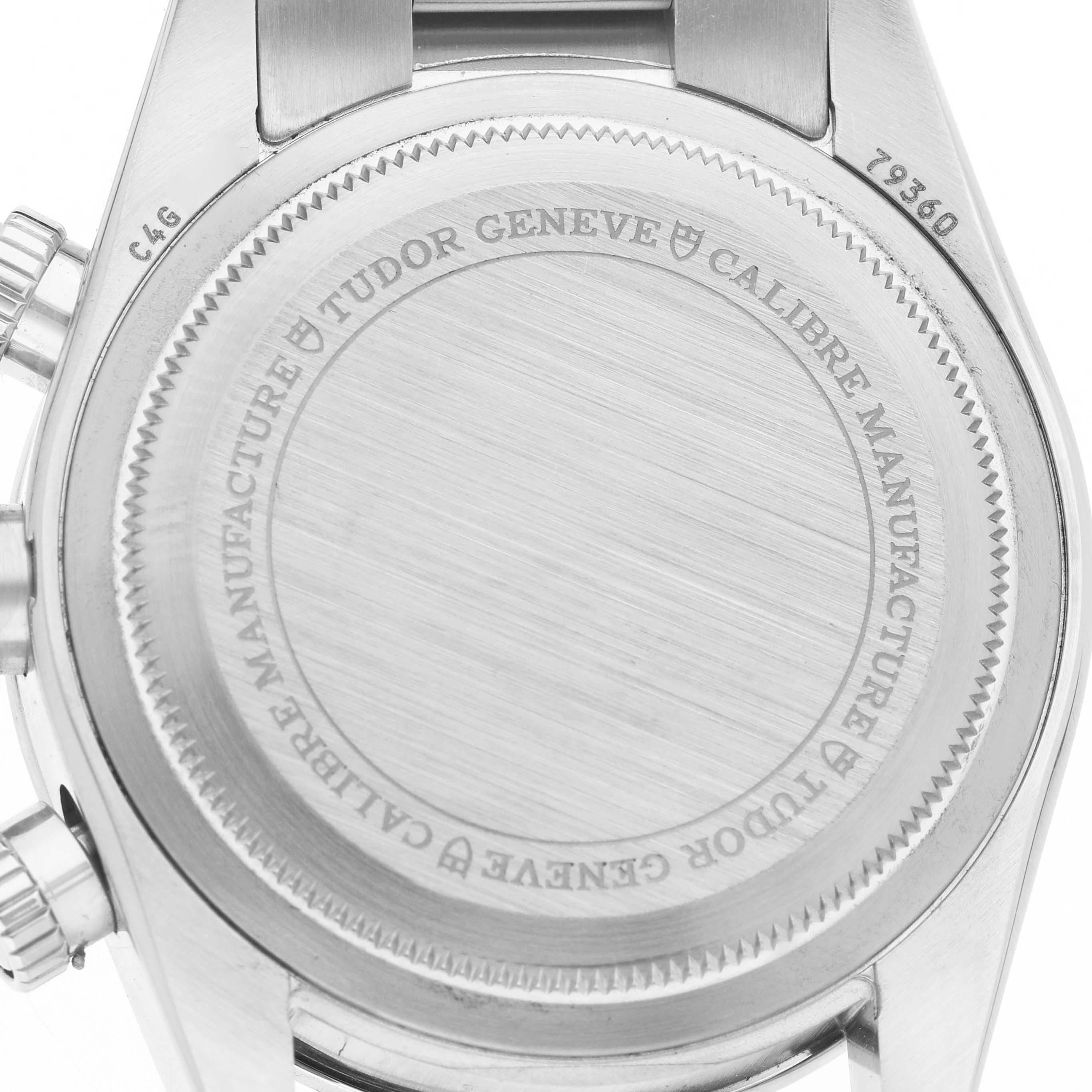 The image shows the back case of a Tudor Heritage Chrono 79360N Men's Stainless Steel Silver Dial watch, highlighting its inscriptions and metal finish.