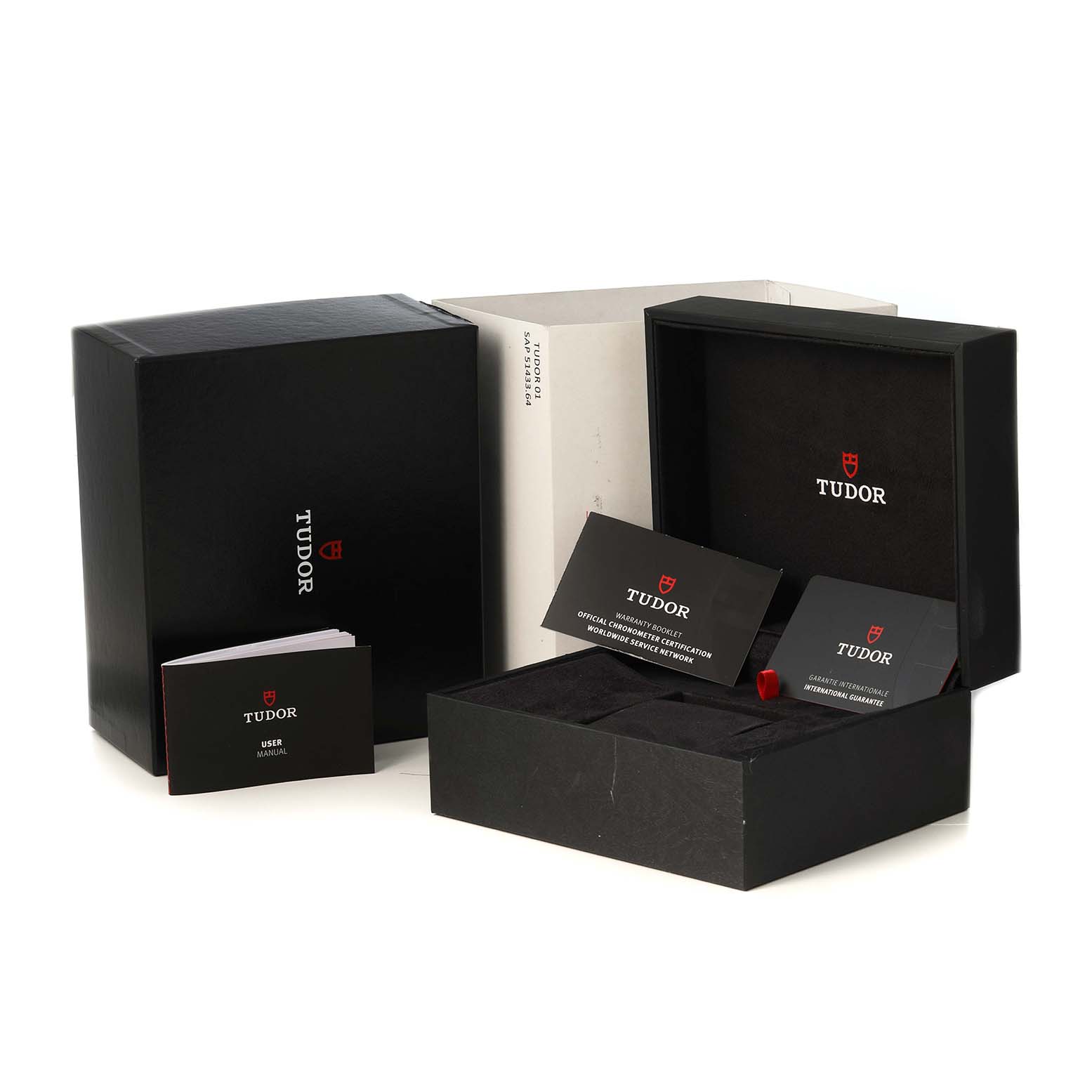 The image shows boxes and manuals for a Tudor Heritage Chrono 79360N-0001 Men's Stainless Steel Black Dial watch, highlighting the packaging and documentation.