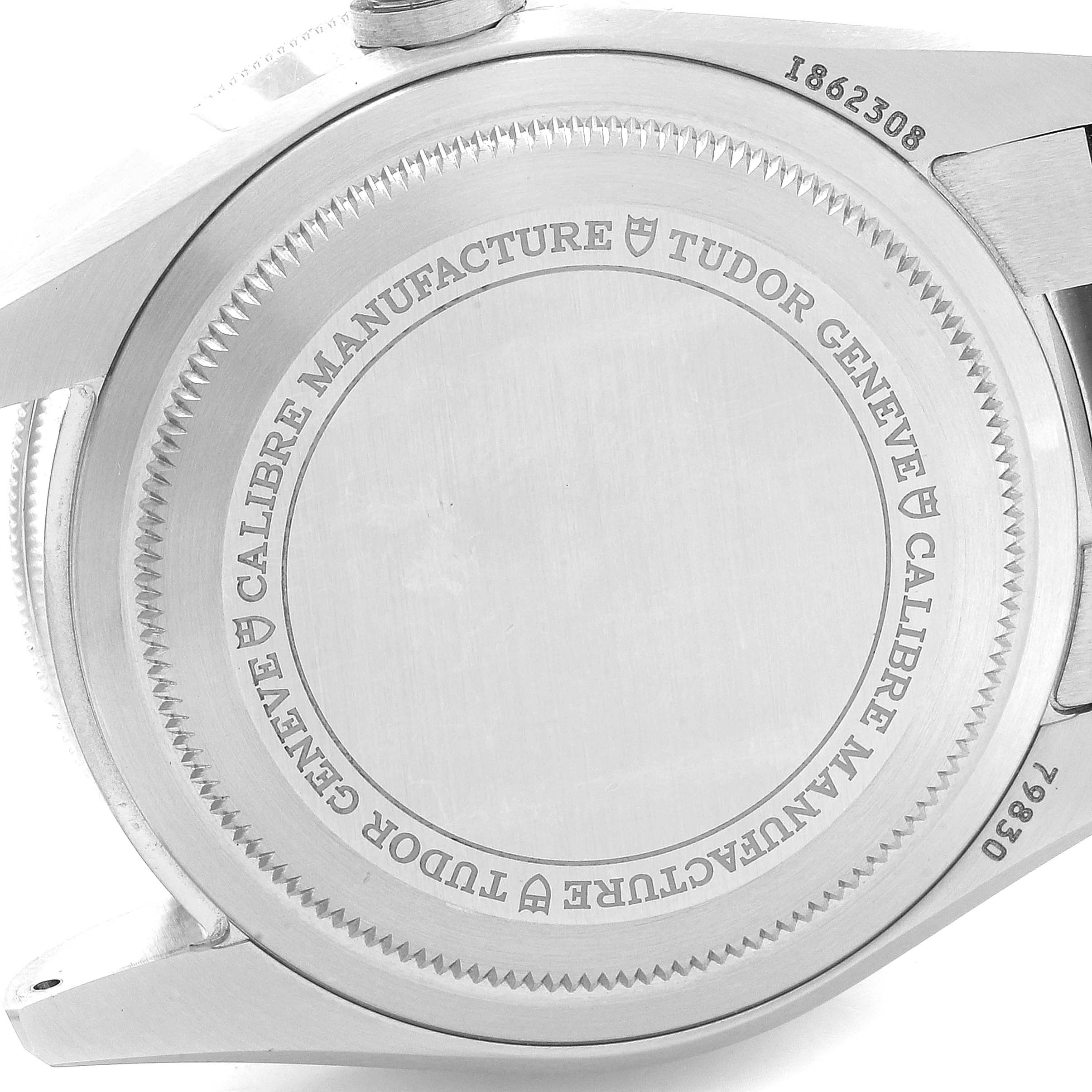 The image shows the case back of a Tudor Heritage Black Bay 79830RB Men
s Stainless Steel Black Dial 79830RB Men
s Stainless Steel Black Dial watch, displaying the brand
s engraving.