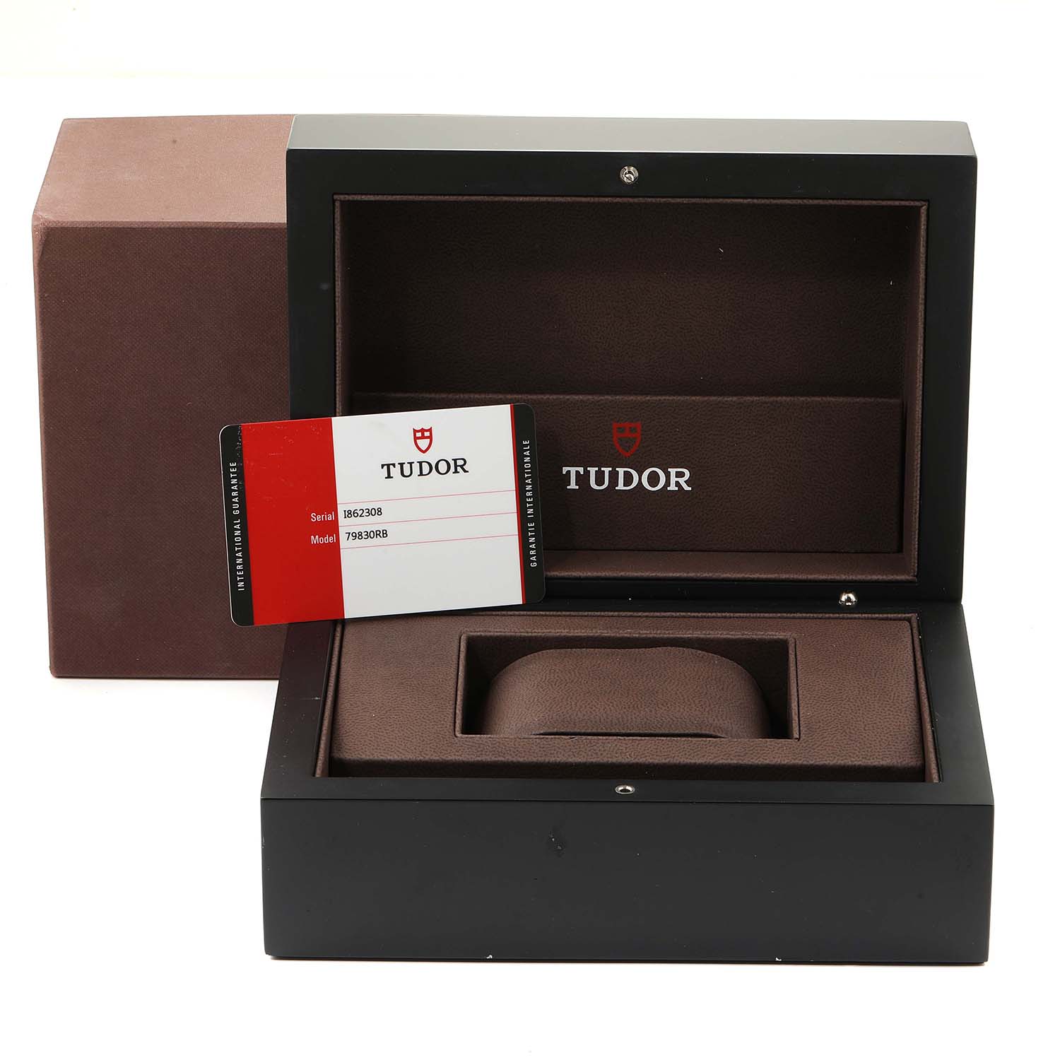 The image shows an open Tudor Heritage Black Bay 79830RB Men
s Stainless Steel Black Dial 79830RB Men
s Stainless Steel Black Dial watch box with a warranty card placed inside.