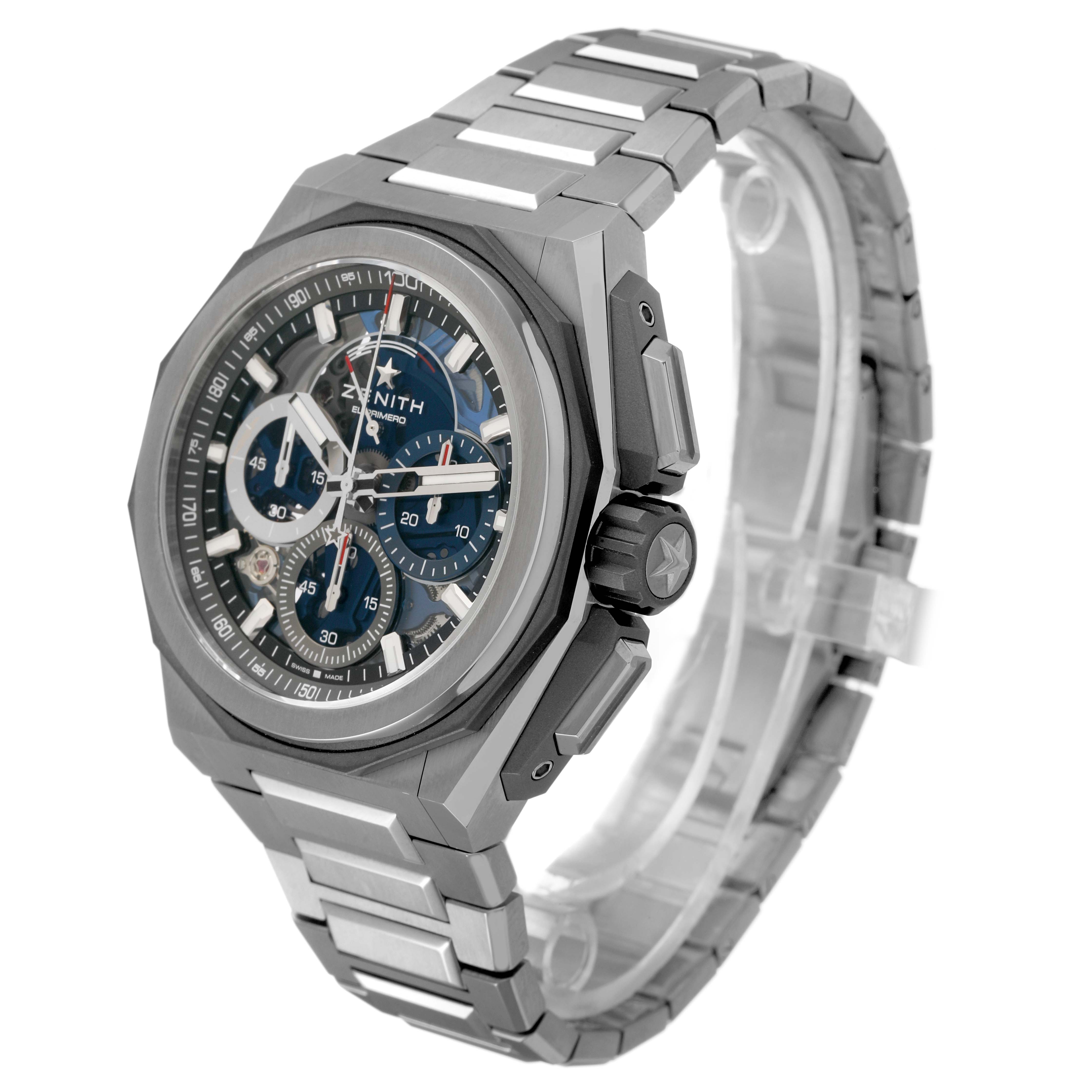 The Zenith Defy 95.9100.9004/01.I001 Men's Titanium Blue Dial watch is shown at an angled side view, highlighting the dial, crown, and metal bracelet.
