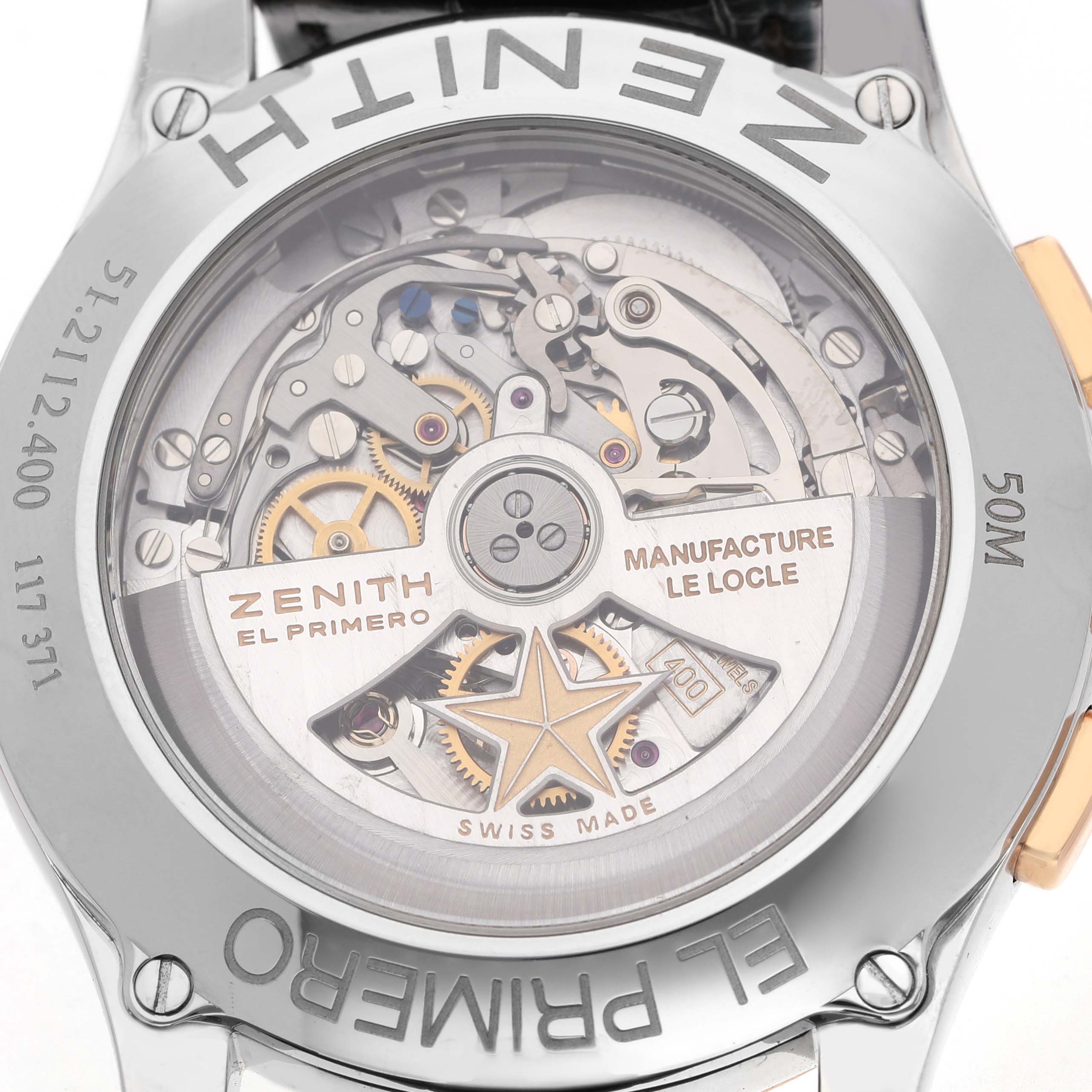 The image shows the back of the Zenith El Primero 51.2112.400/01.C498 Men's Steel and Gold (two tone) Silver Dial watch, highlighting its exposed movement and gears through a transparent case back.