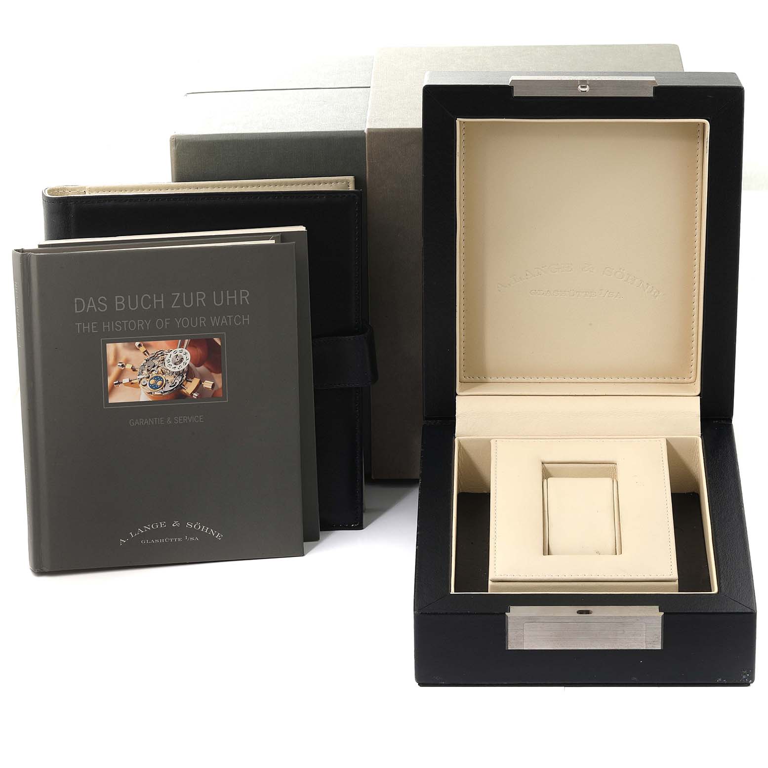 The image displays an open watch box, instruction manuals, and packaging for a Richard Lange model by A. Lange & Söhne.