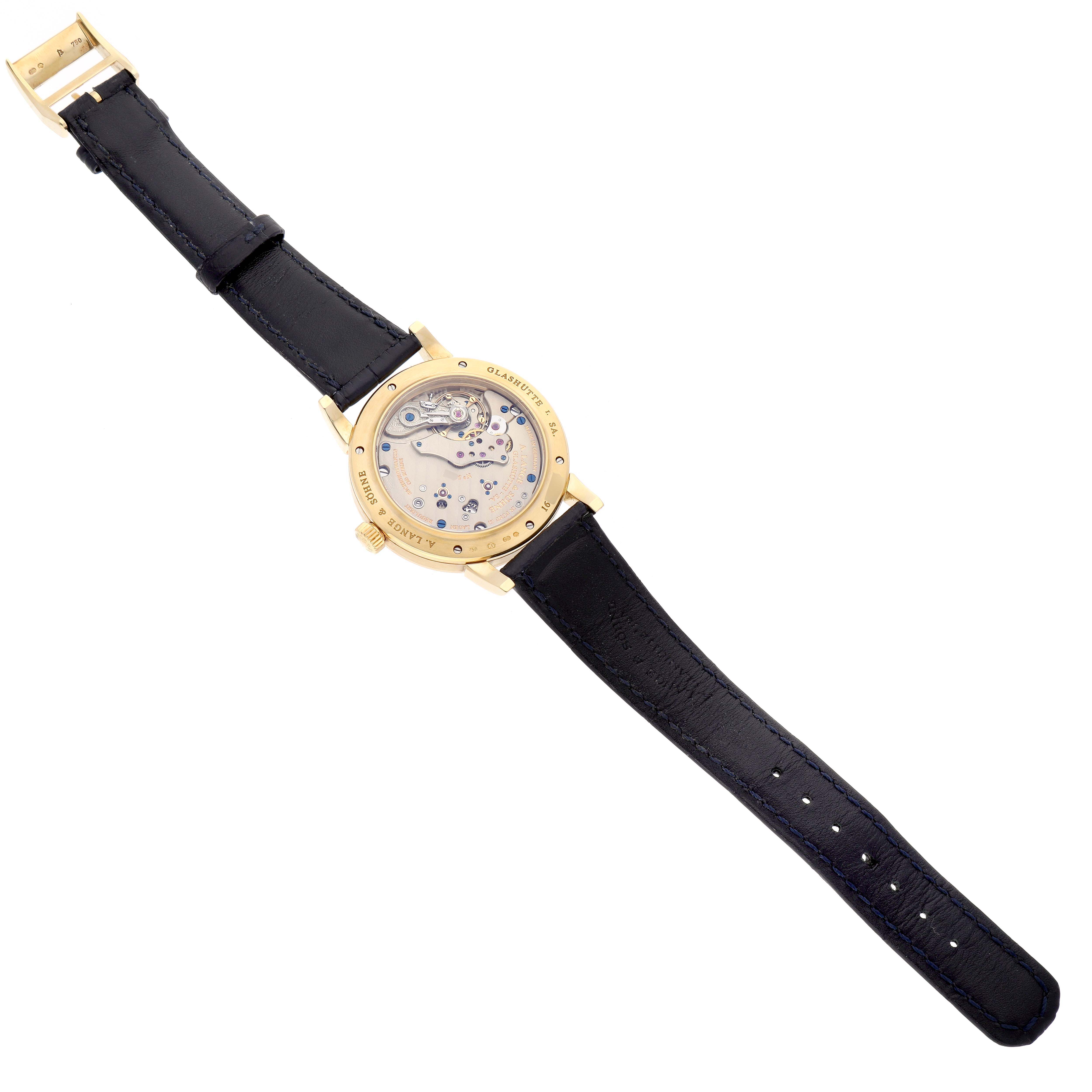 The image shows the back view of the Richard Lange model by A. Lange & Söhne, displaying its intricate mechanical movement and black strap.