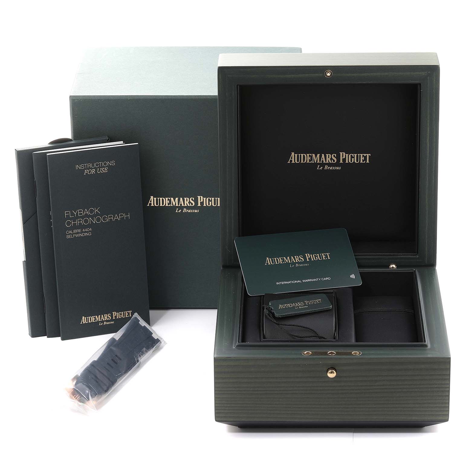 The image shows the packaging and accessories for an Audemars Piguet Royal Oak Offshore 26238OR.OO.2000OR.01 Men's Rose Gold Blue Dial 26238OR.OO.2000OR.01 Men's Rose Gold Blue Dial, including the box, manuals, and an extra strap.