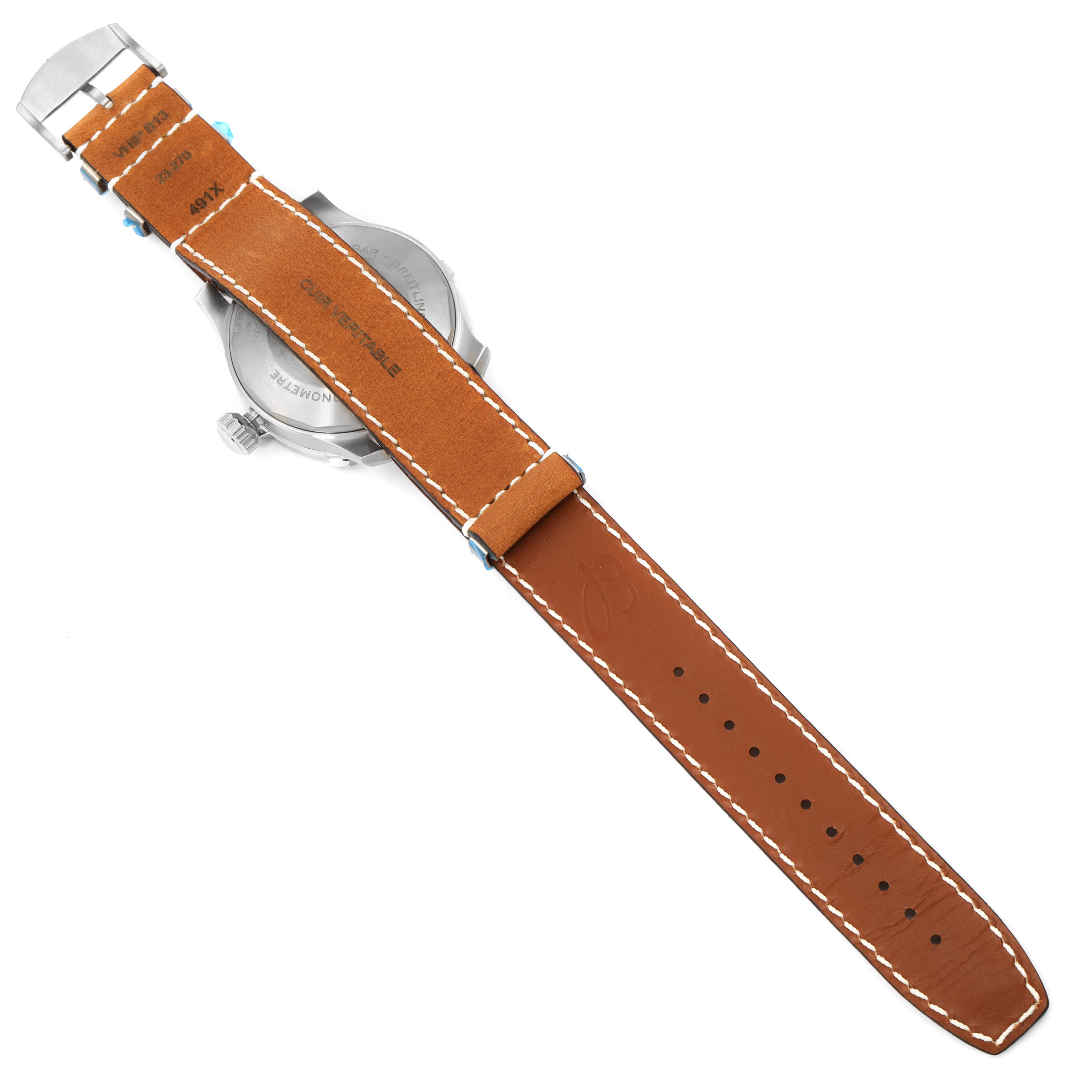 The image shows the back view of a Breitling Navitimer watch with a brown leather strap and a metal clasp.