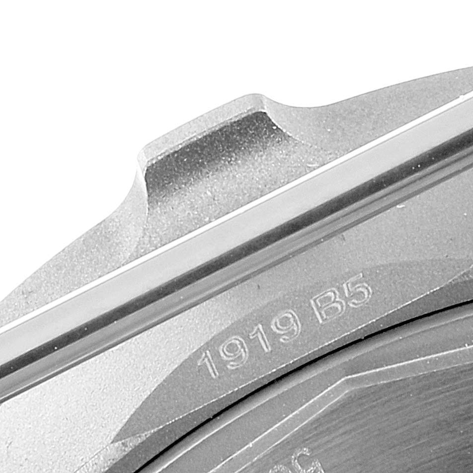 The image shows the engraved serial number on the back casing of a Breitling Navitimer watch, viewed at a close angle.