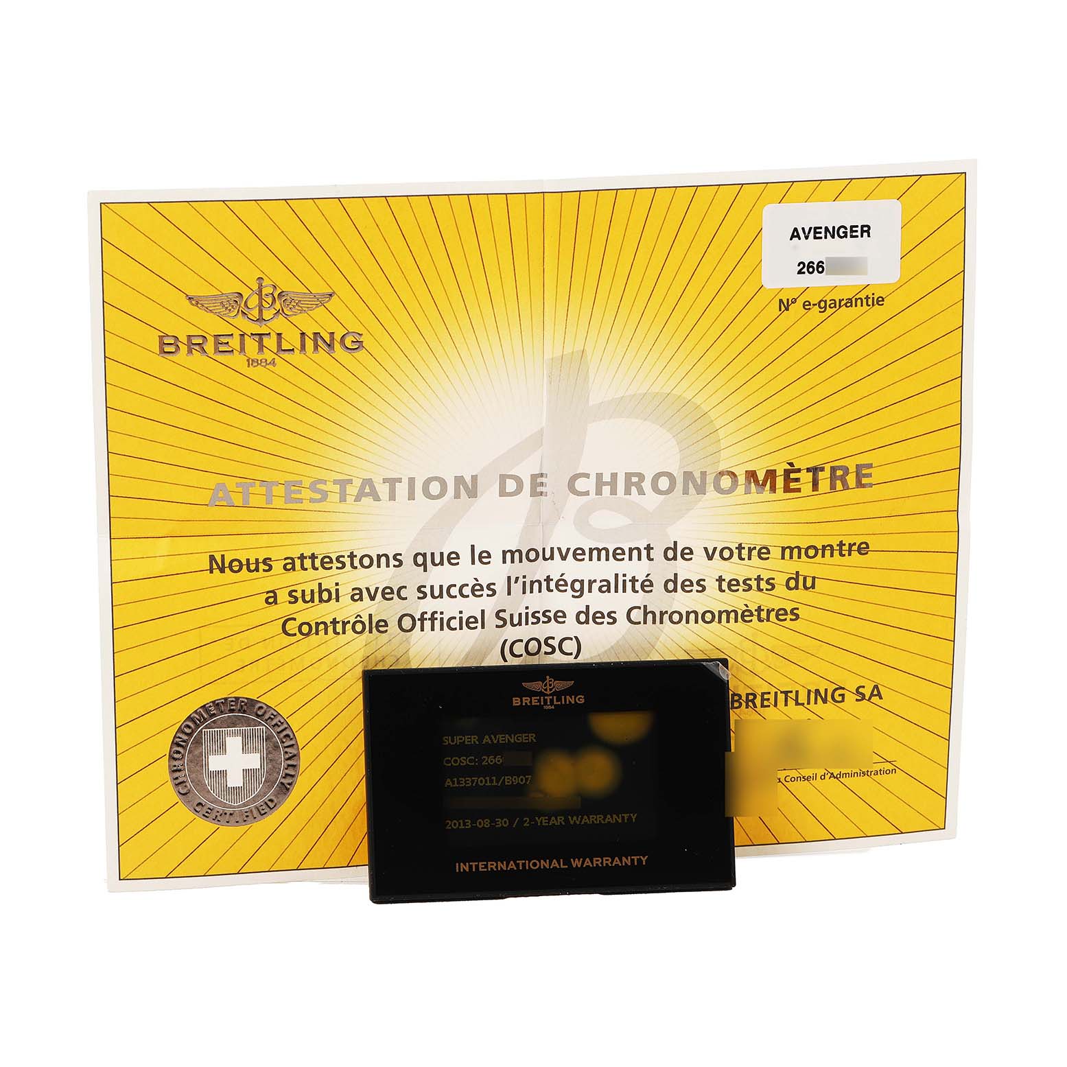 The image shows a Breitling Avenger A1337011 / B907 Men's Stainless Steel Black Dial watch certificate and international warranty card placed at a slight angle.