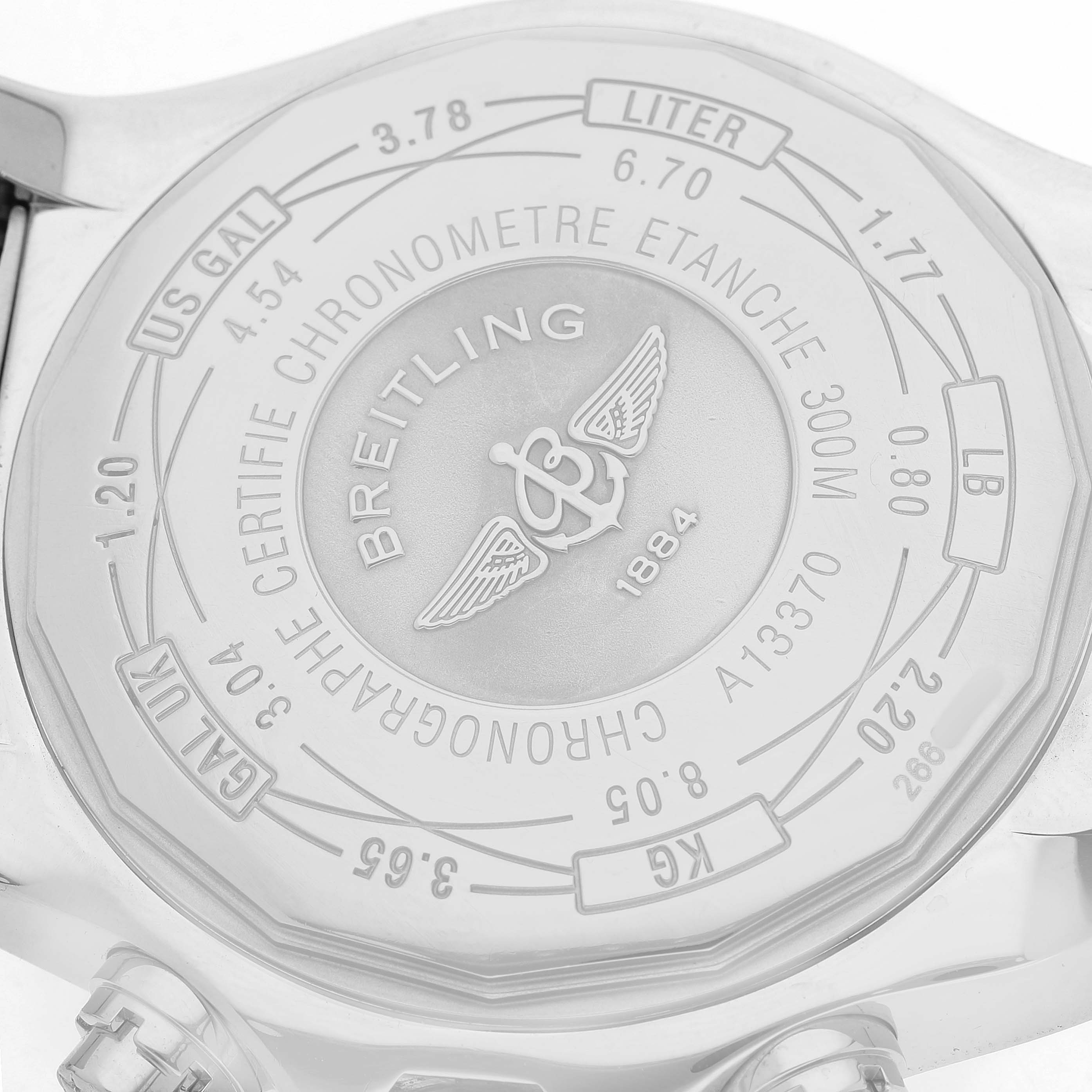 The image shows the back case of a Breitling Avenger A1337011 / B907 Men's Stainless Steel Black Dial watch, displaying engravings, branding, and specifications.