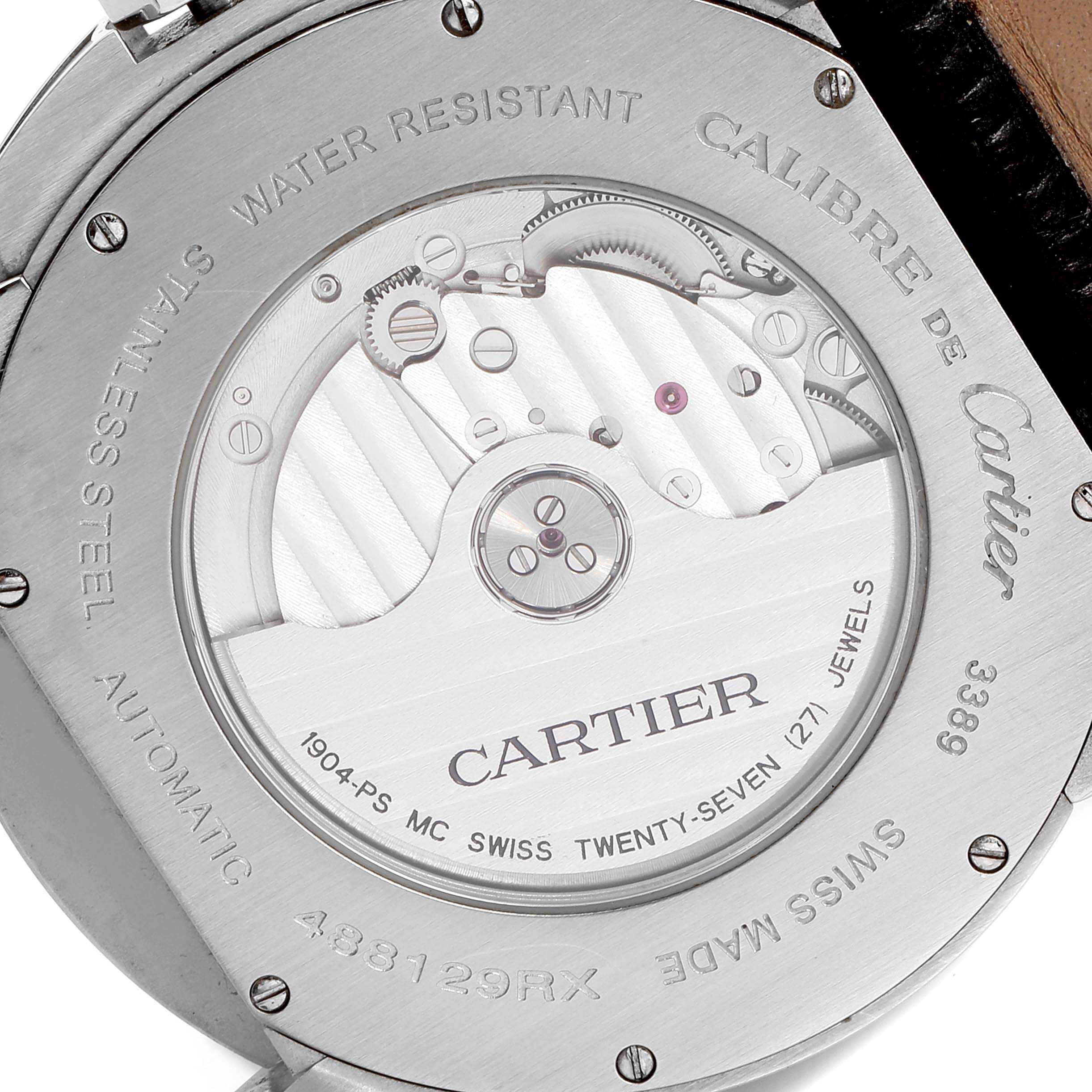 The image shows the back case of a Calibre de Cartier watch by Cartier, displaying its internal mechanical movement.
