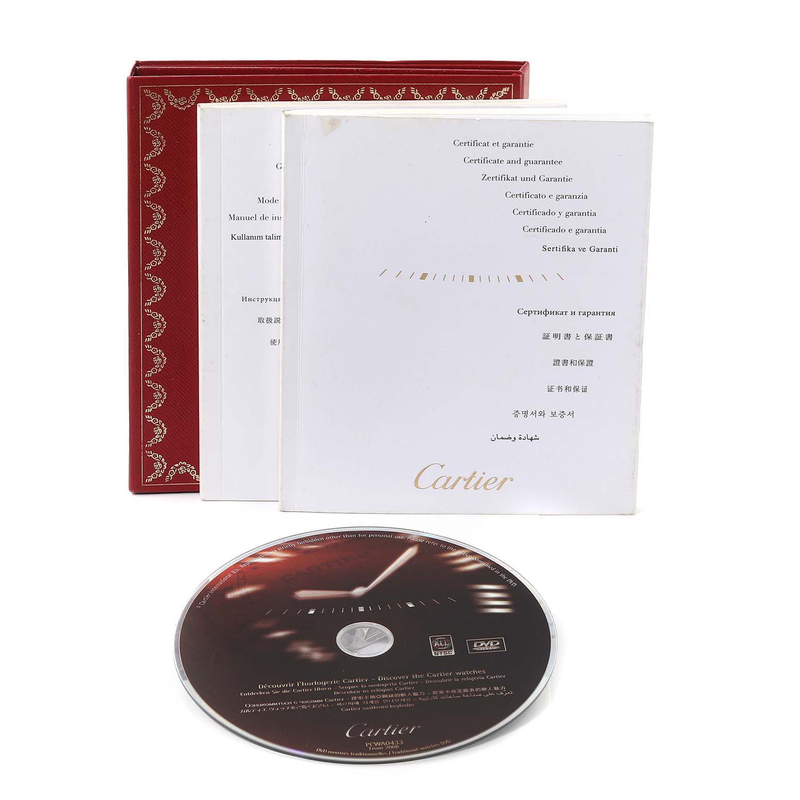 The image shows the certificates, manuals, and a DVD for the Calibre de Cartier watch by Cartier.
