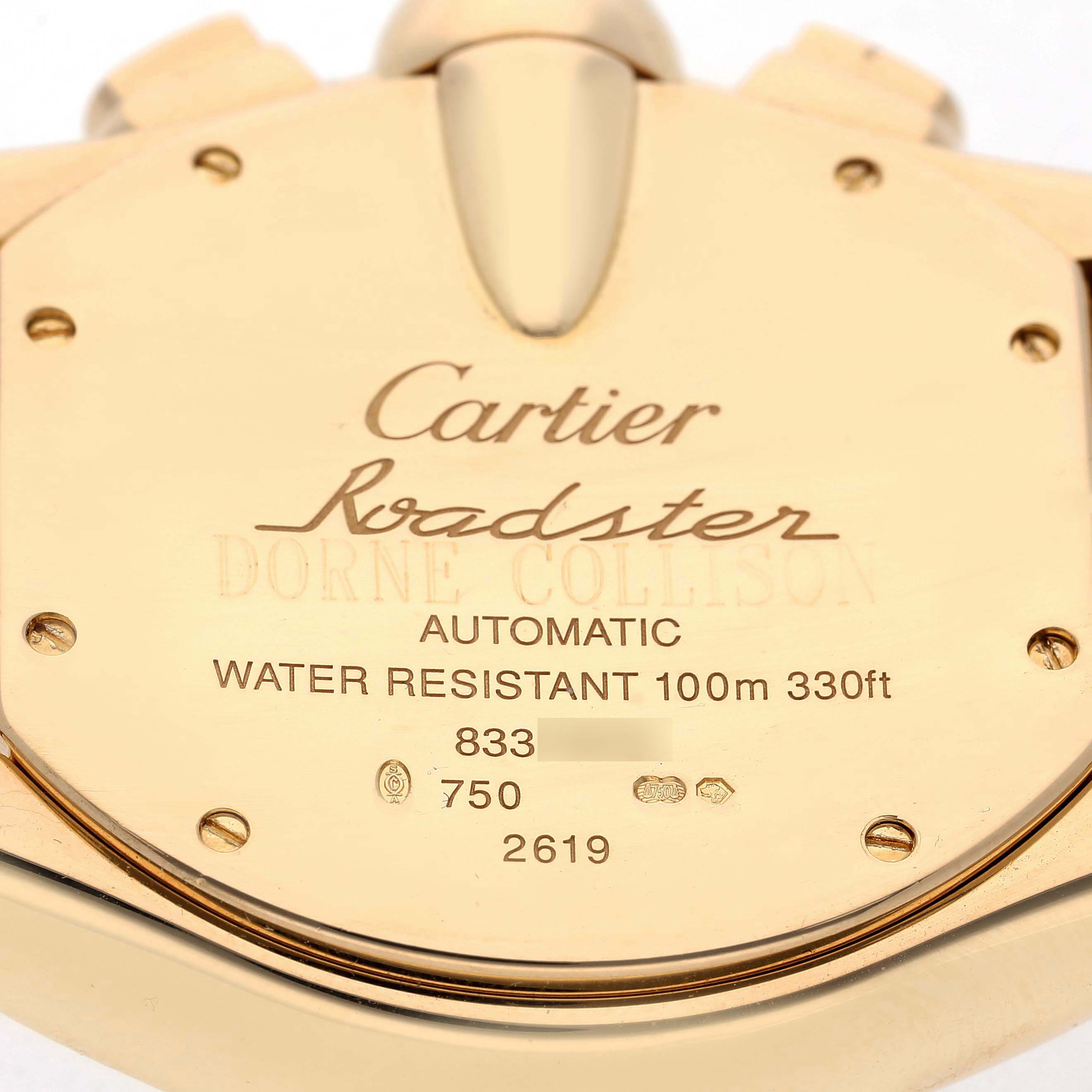 The image shows the back of a Cartier Roadster W62021Y2 Men's Yellow Gold Silver Dial watch, highlighting engravings and water resistance details.