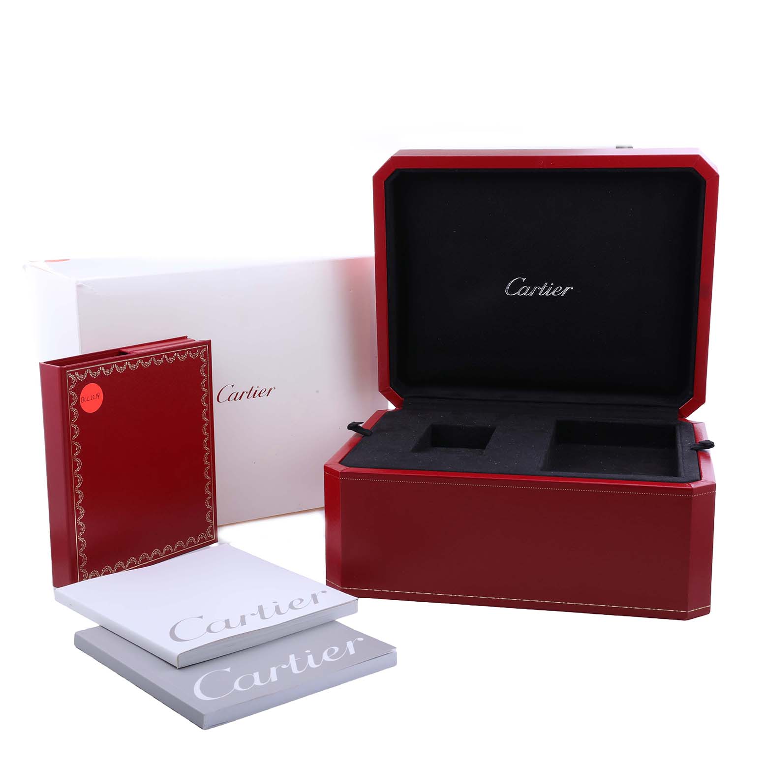 The image shows accessories for a Cartier Roadster W62021Y2 Men's Yellow Gold Silver Dial watch, including an open red box and booklets.