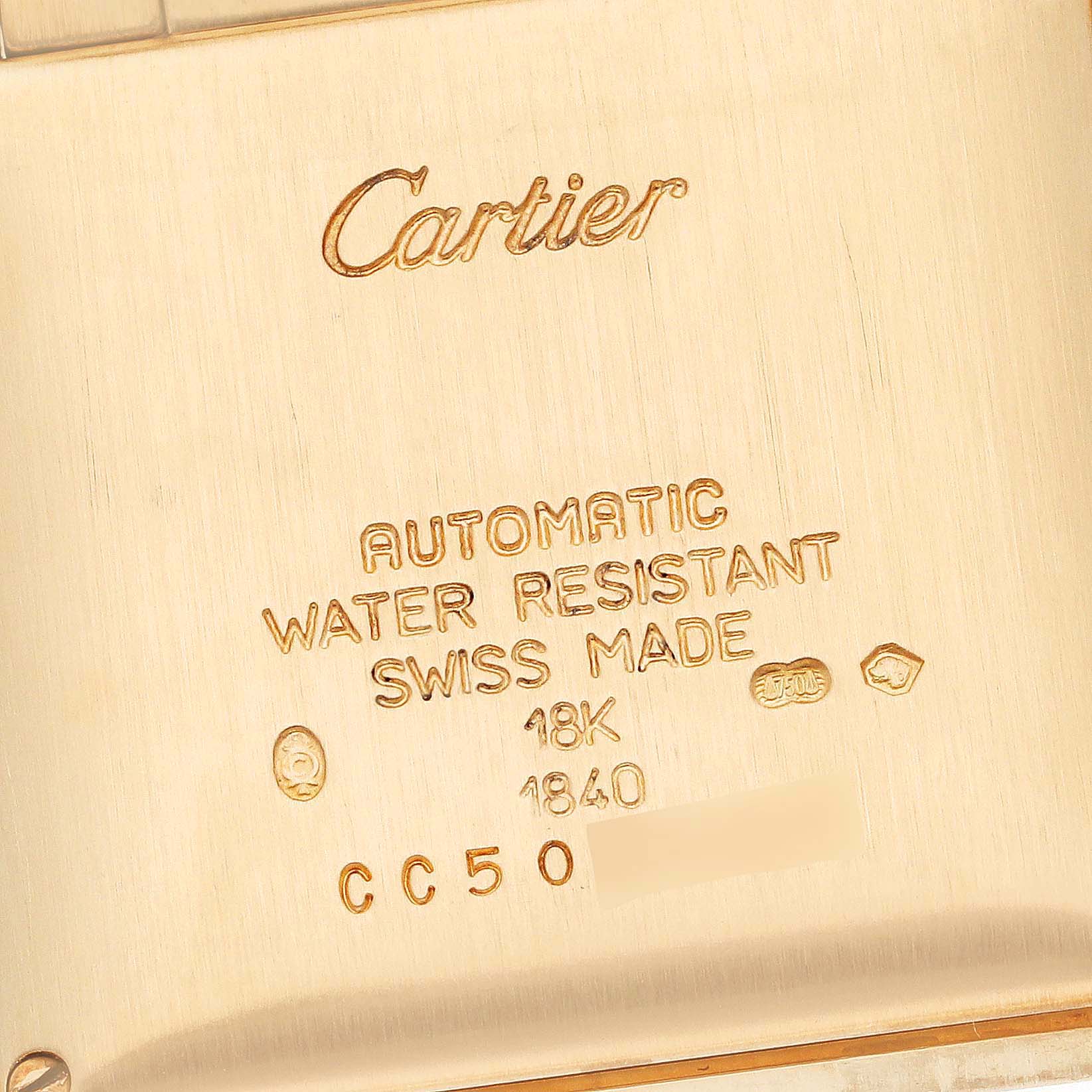 This is a close-up of the back case of the Cartier Tank Francaise W50001R2 Men
s Yellow Gold Silver Dial W50001R2 Men
s Yellow Gold Silver Dial watch displaying text detailing the model
s specifications.