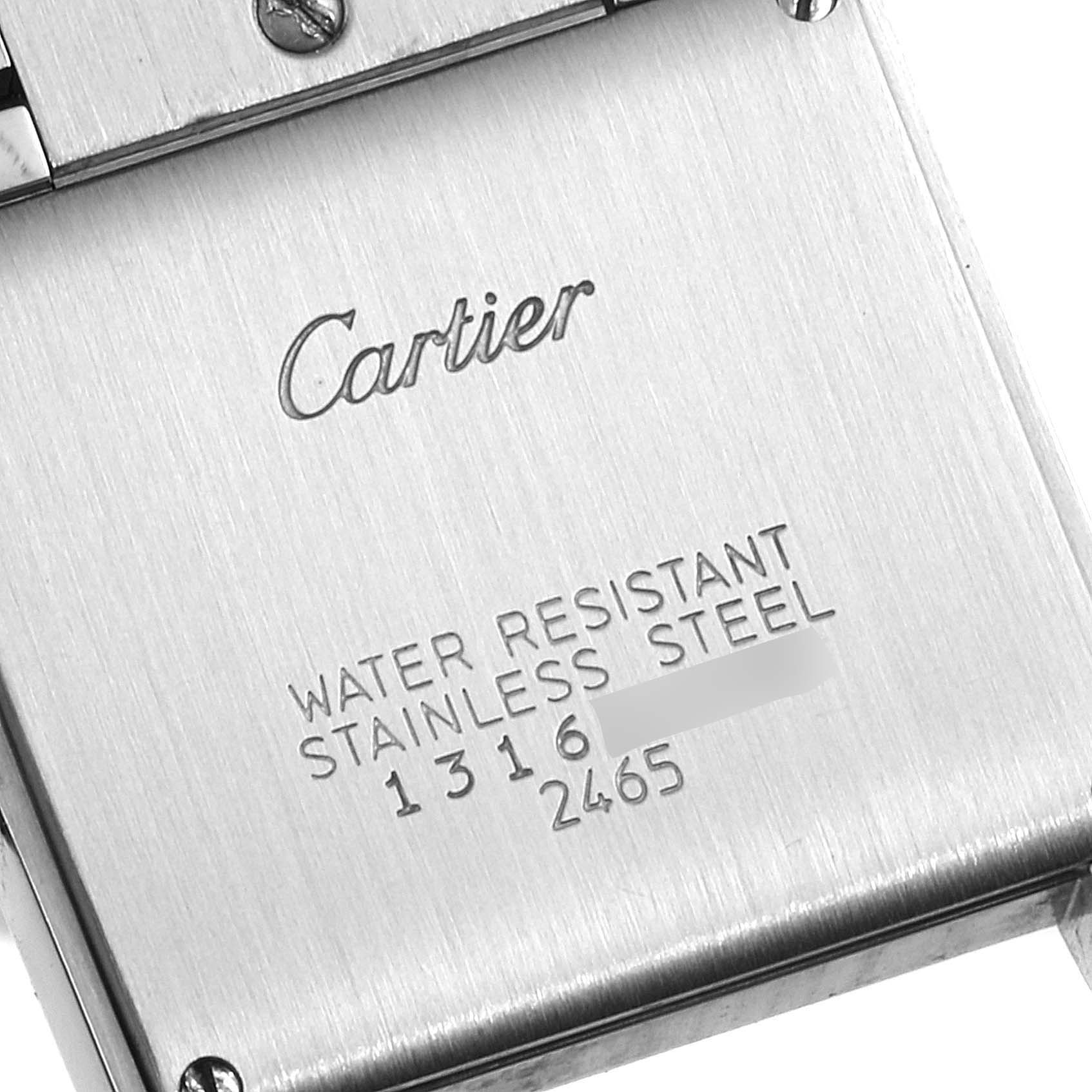 The image shows the back case of a Cartier Tank Francaise W51012Q4 Women's Steel and Gold (two tone) Silver Dial W51012Q4 Women's Steel and Gold (two tone) Silver Dial watch, displaying its engravings and metal finish.