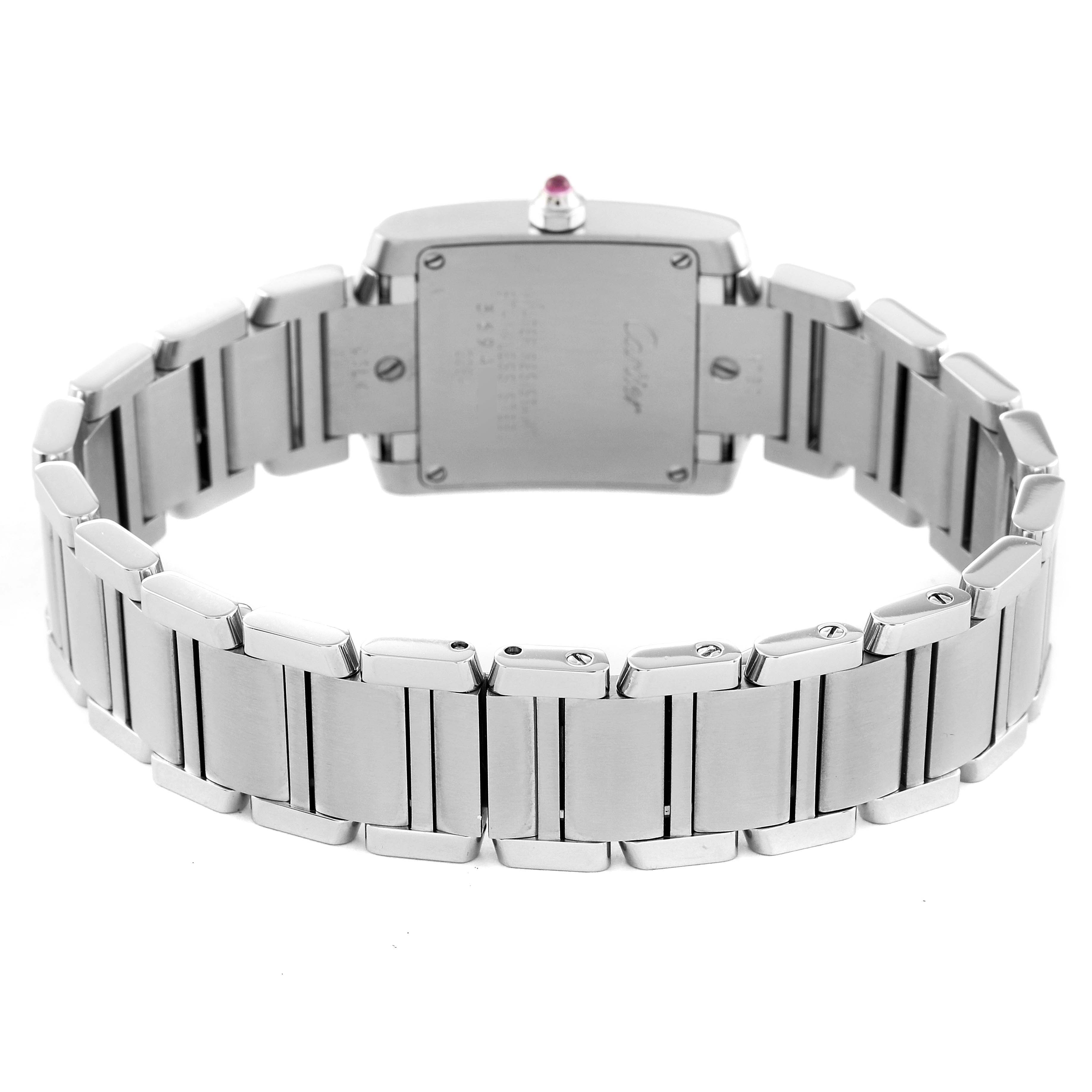 The image shows the back view of a Cartier Tank Française watch, highlighting its stainless steel bracelet and caseback.