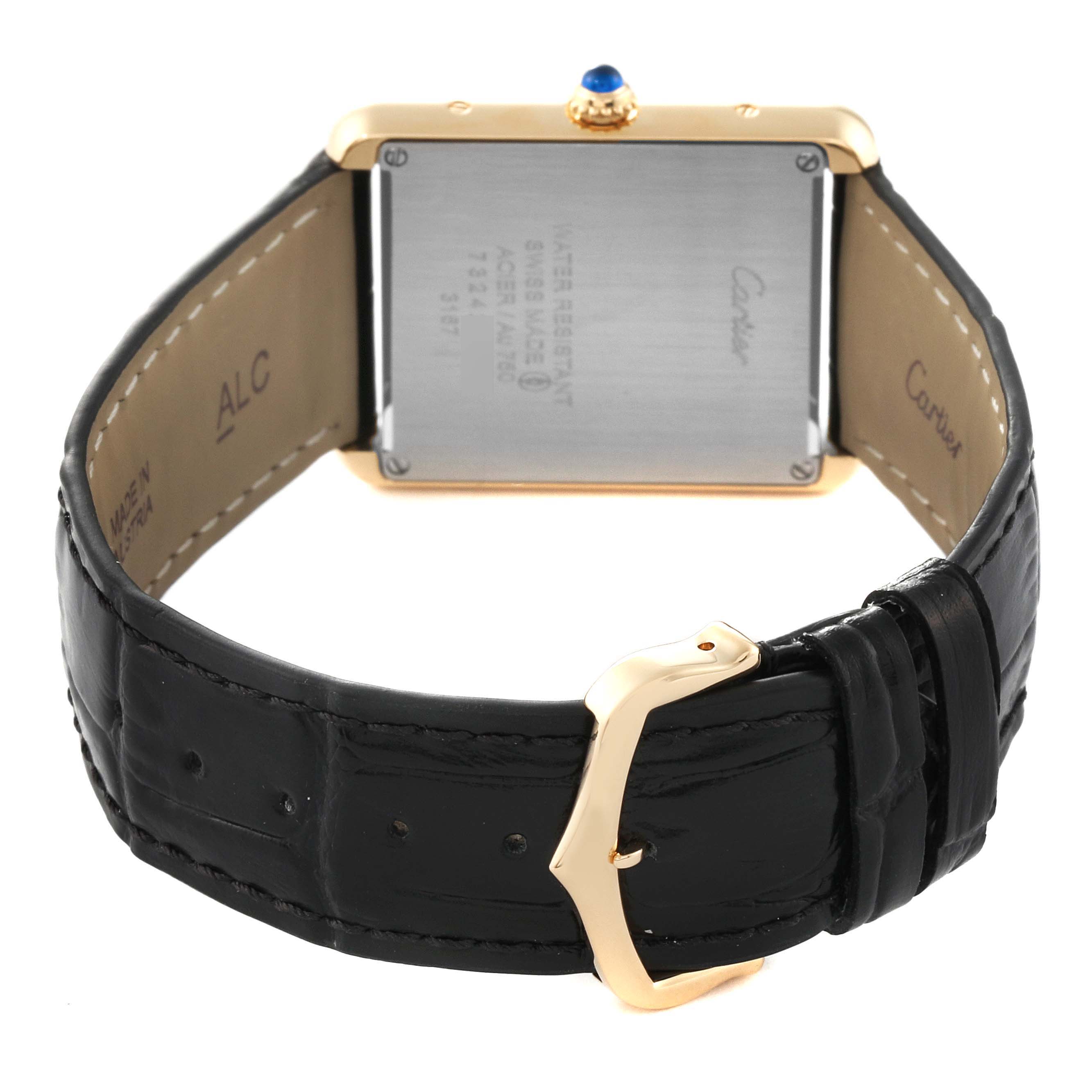 The image shows the rear view of the Tank Solo model by Cartier, highlighting the watch's back casing and black leather strap with a gold buckle.