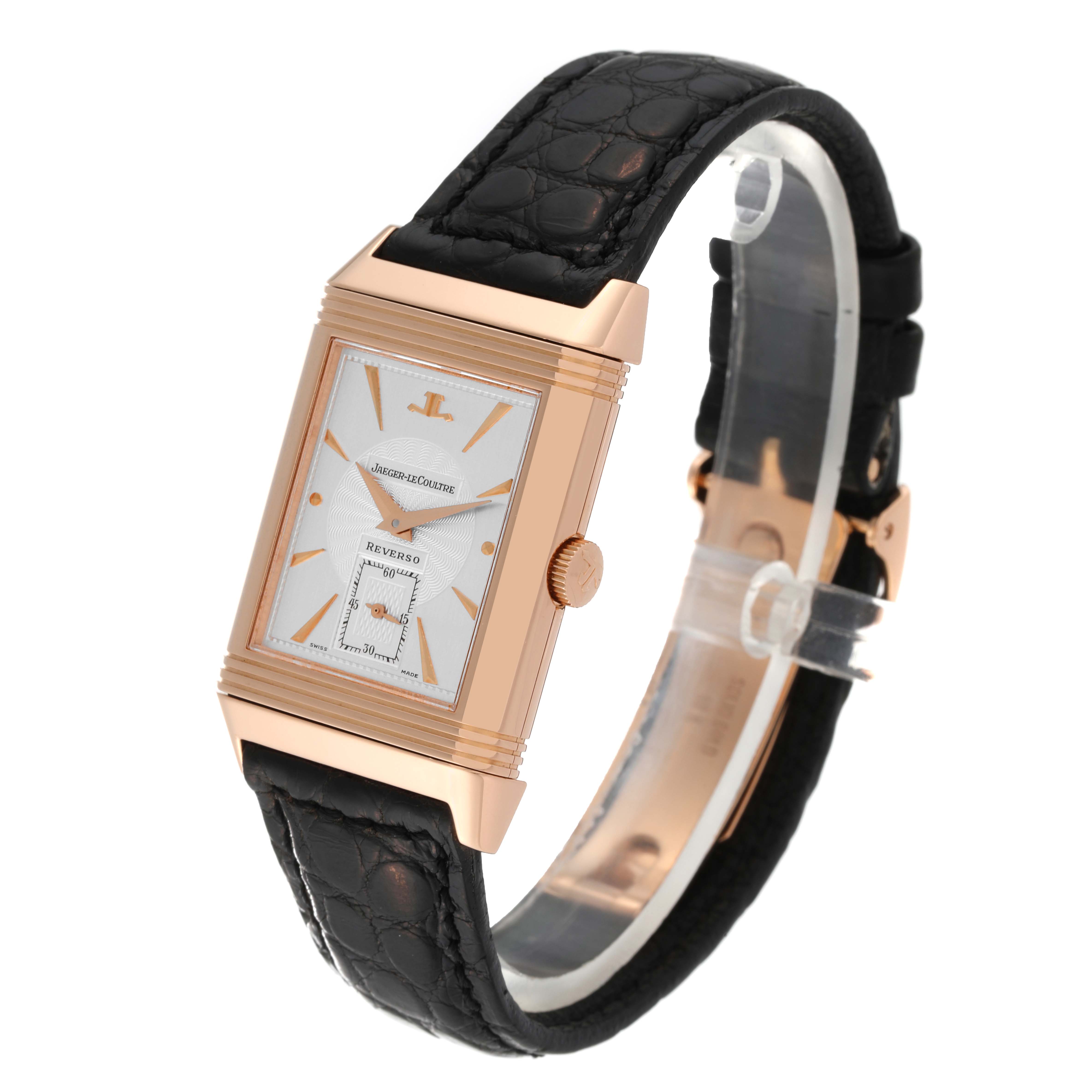 The Jaeger LeCoultre Reverso 270.2.62 Men's Rose Gold Silver Dial 270.2.62 Men's Rose Gold Silver Dial watch is shown at a 3/4 angle, highlighting its rectangular face, crown, and black leather strap.