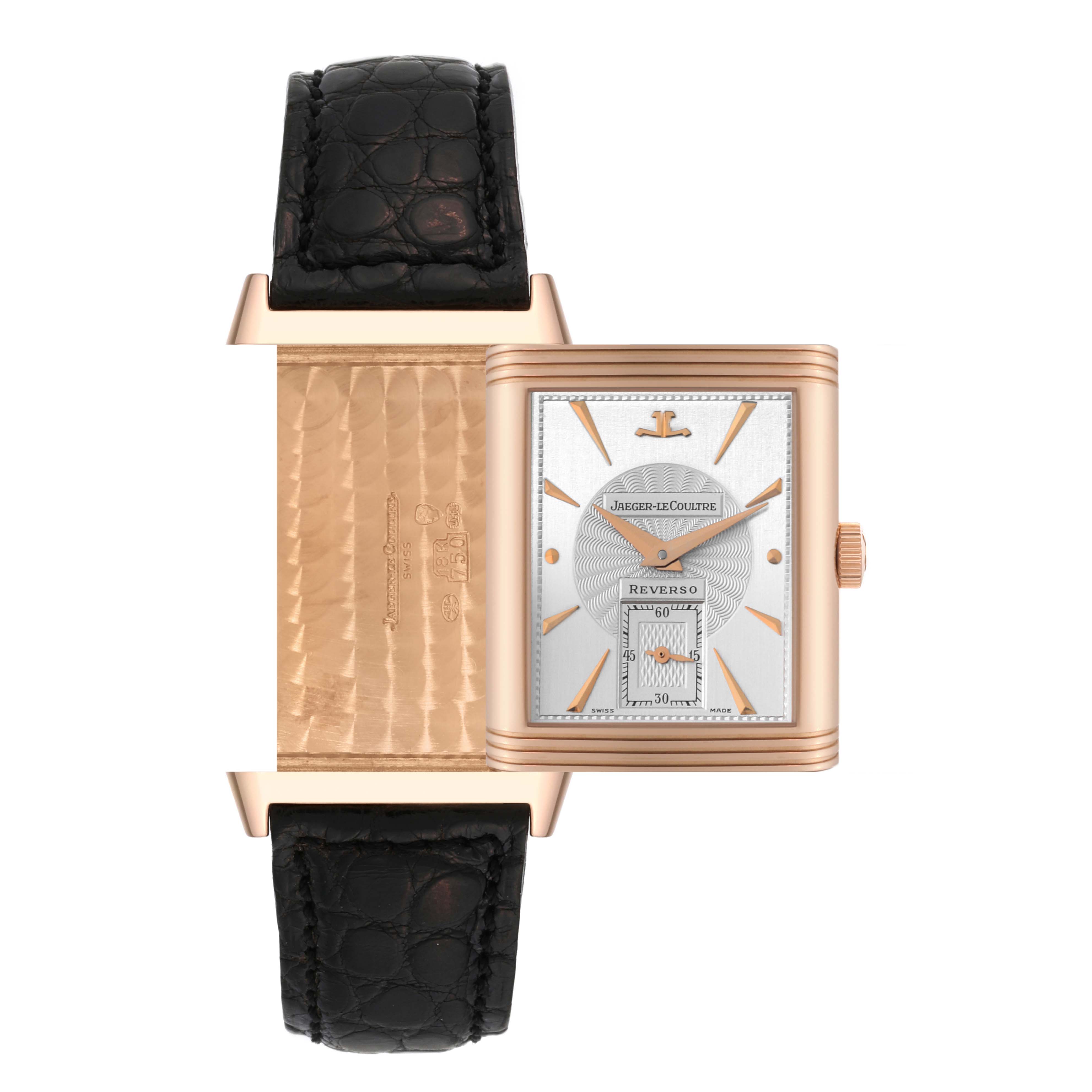 The image shows the Jaeger LeCoultre Reverso 270.2.62 Men's Rose Gold Silver Dial 270.2.62 Men's Rose Gold Silver Dial watch with its reversible case open, revealing the back and front dials and the black watch strap.