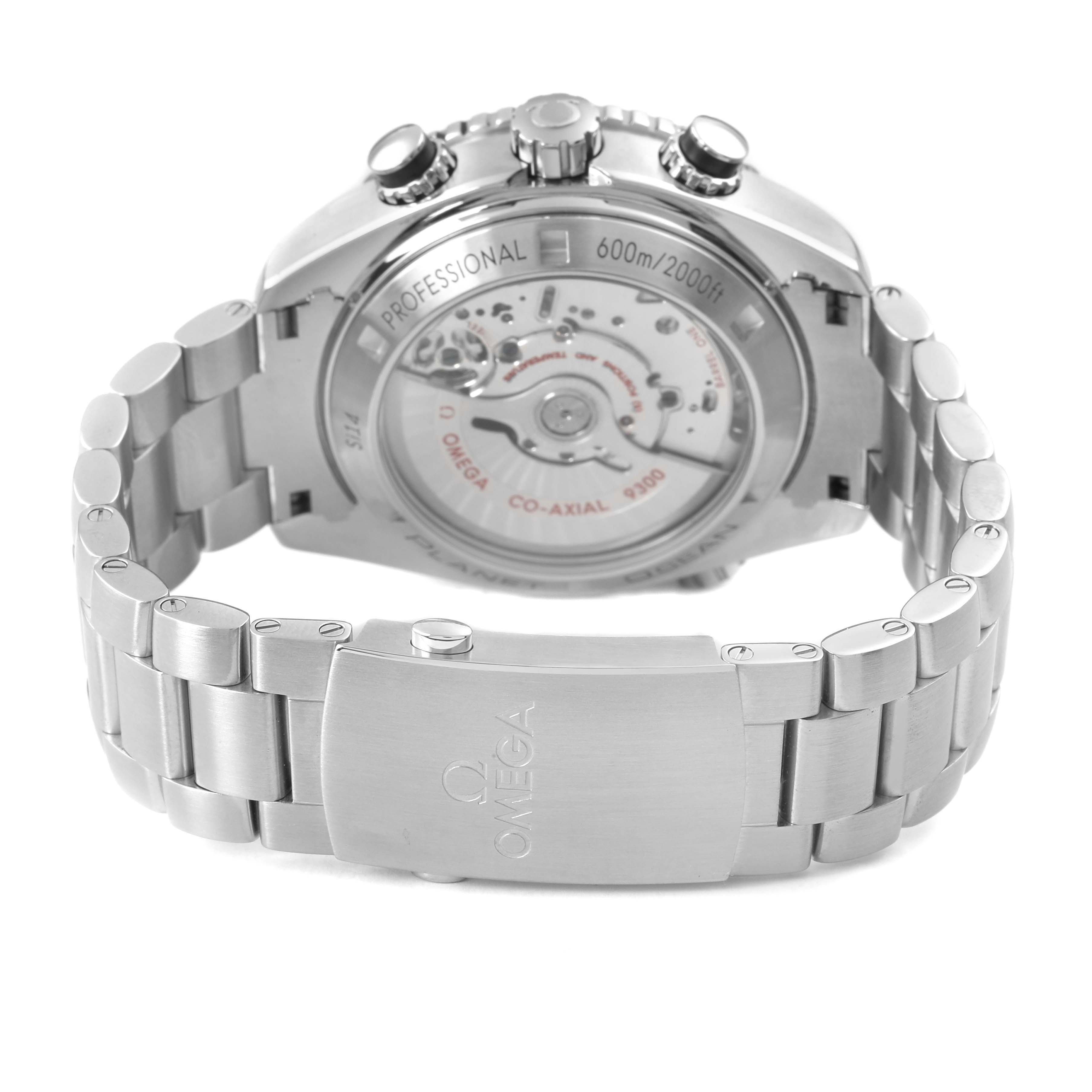 The image shows the back view of the Omega Planet Ocean 232.30.46.51.01.001 Men's Stainless Steel Black Dial, highlighting the movement through the transparent case back and metal bracelet.