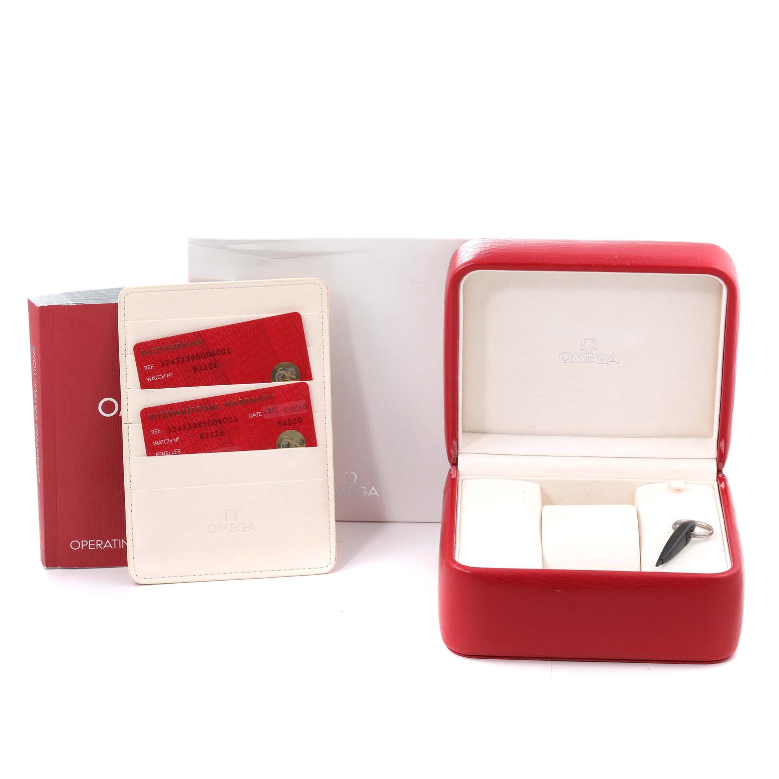 The image shows the Omega Speedmaster 324.32.38.50.06.001 Men
s Stainless Steel Grey Dial 324.32.38.50.06.001 Men
s Stainless Steel Grey Dial packaging, including the box, warranty cards, cardholder, and operating instructions.