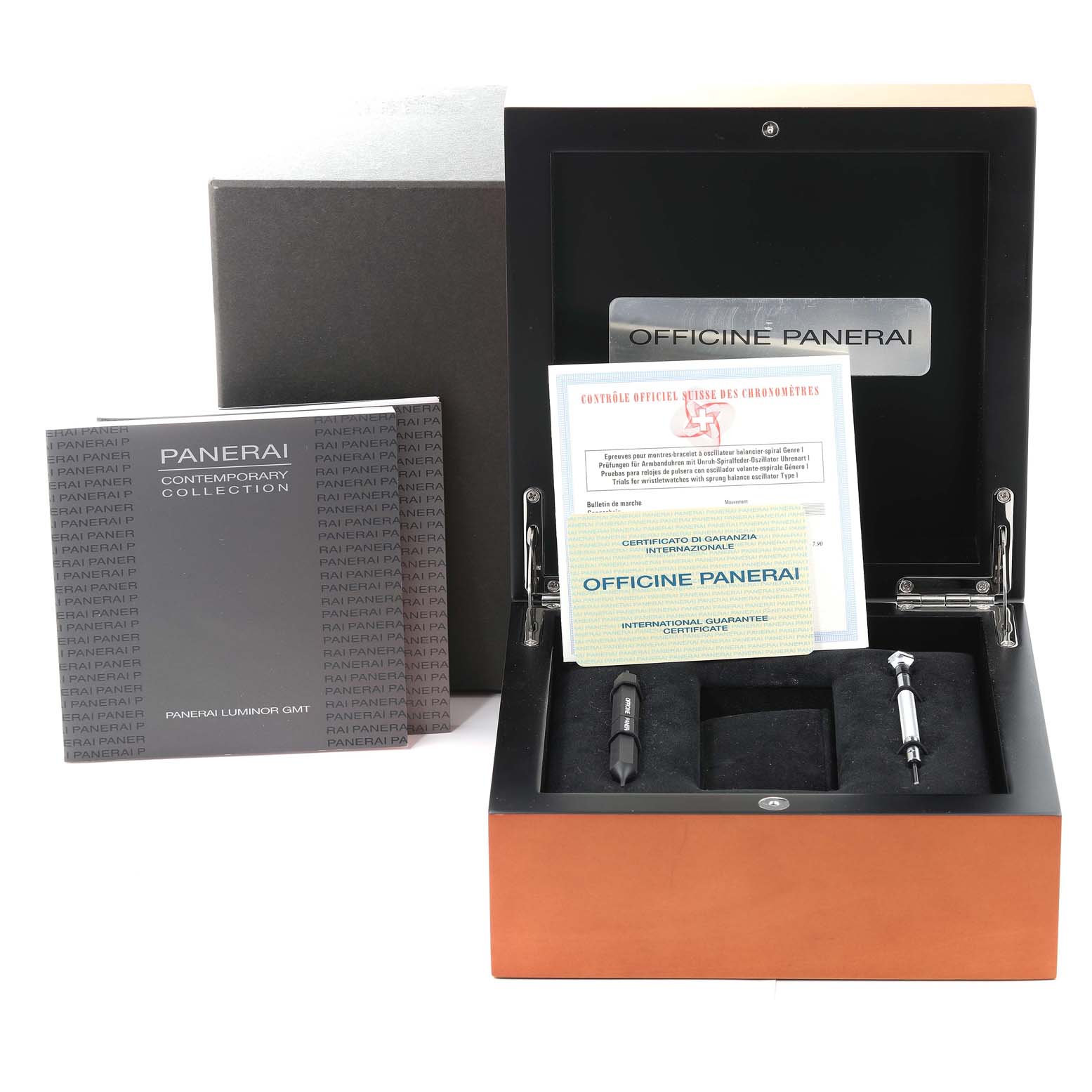 The image shows the open box of a Panerai Luminor PAM00161 Men
s Stainless Steel Black Dial PAM00161 Men
s Stainless Steel Black Dial model, containing tools, guarantee certificates, and a booklet.