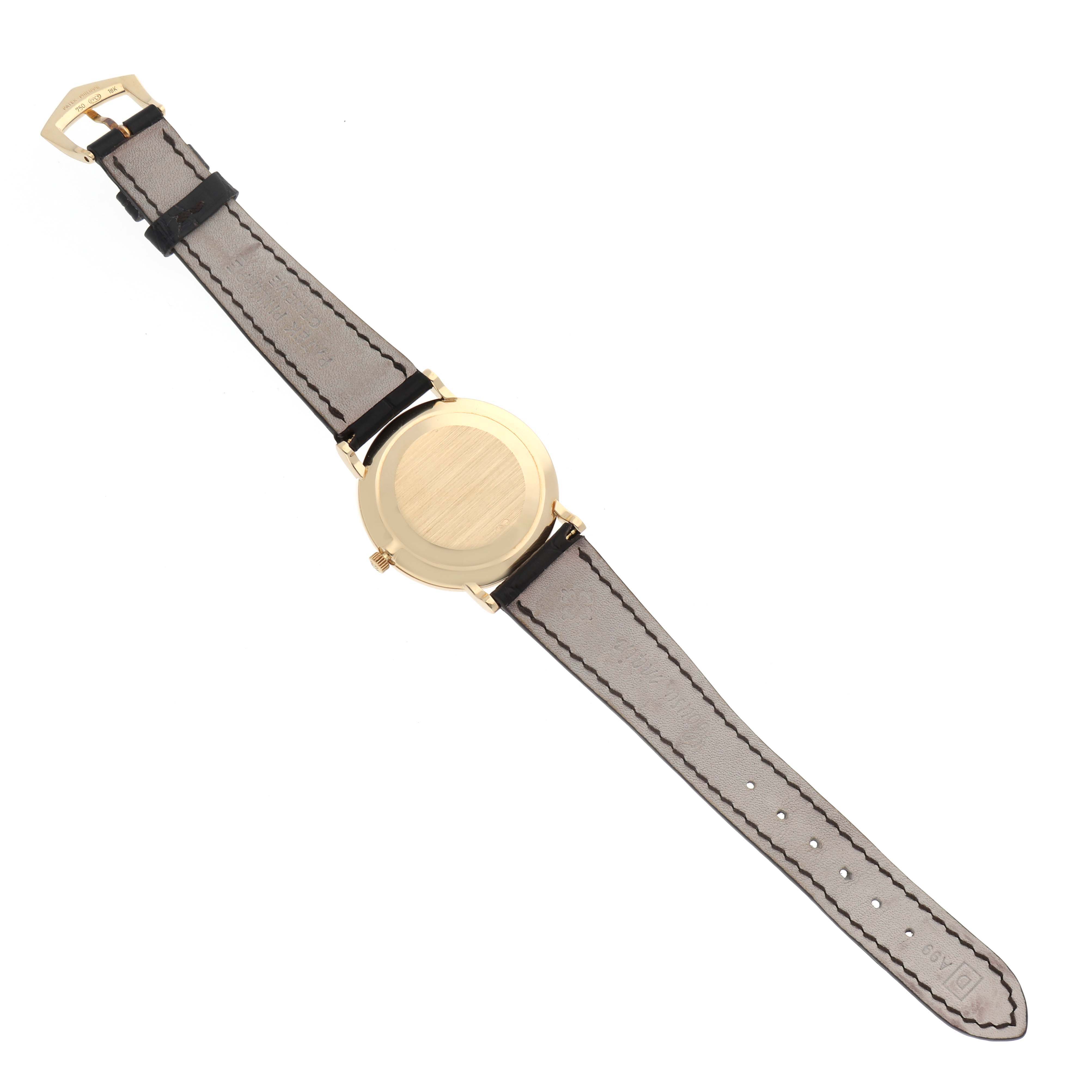 This image shows the back view of a Patek Philippe Calatrava 5022 Men's Yellow Gold Champagne Dial 5022 Men's Yellow Gold Champagne Dial watch, highlighting the caseback and strap.