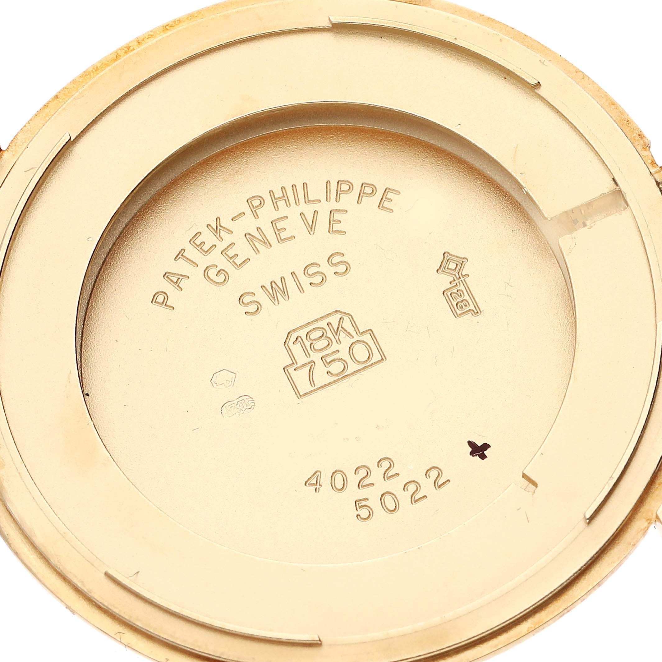 This is the interior of the case back of a Patek Philippe Calatrava 5022 Men's Yellow Gold Champagne Dial 5022 Men's Yellow Gold Champagne Dial watch, showing engravings and markings.