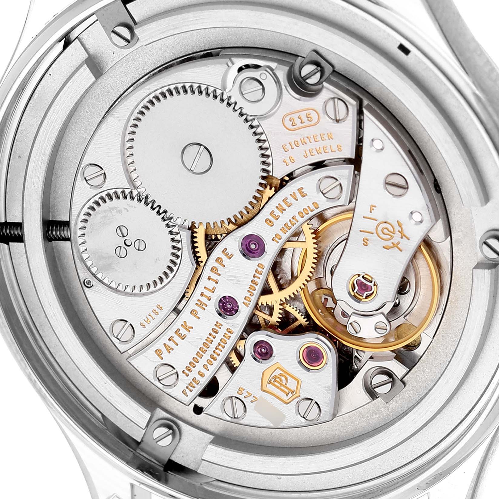 The image shows a close-up view of the movement inside a Patek Philippe Calatrava 4897G-001 Women's White Gold Blue Dial watch, highlighting gears and jewels.