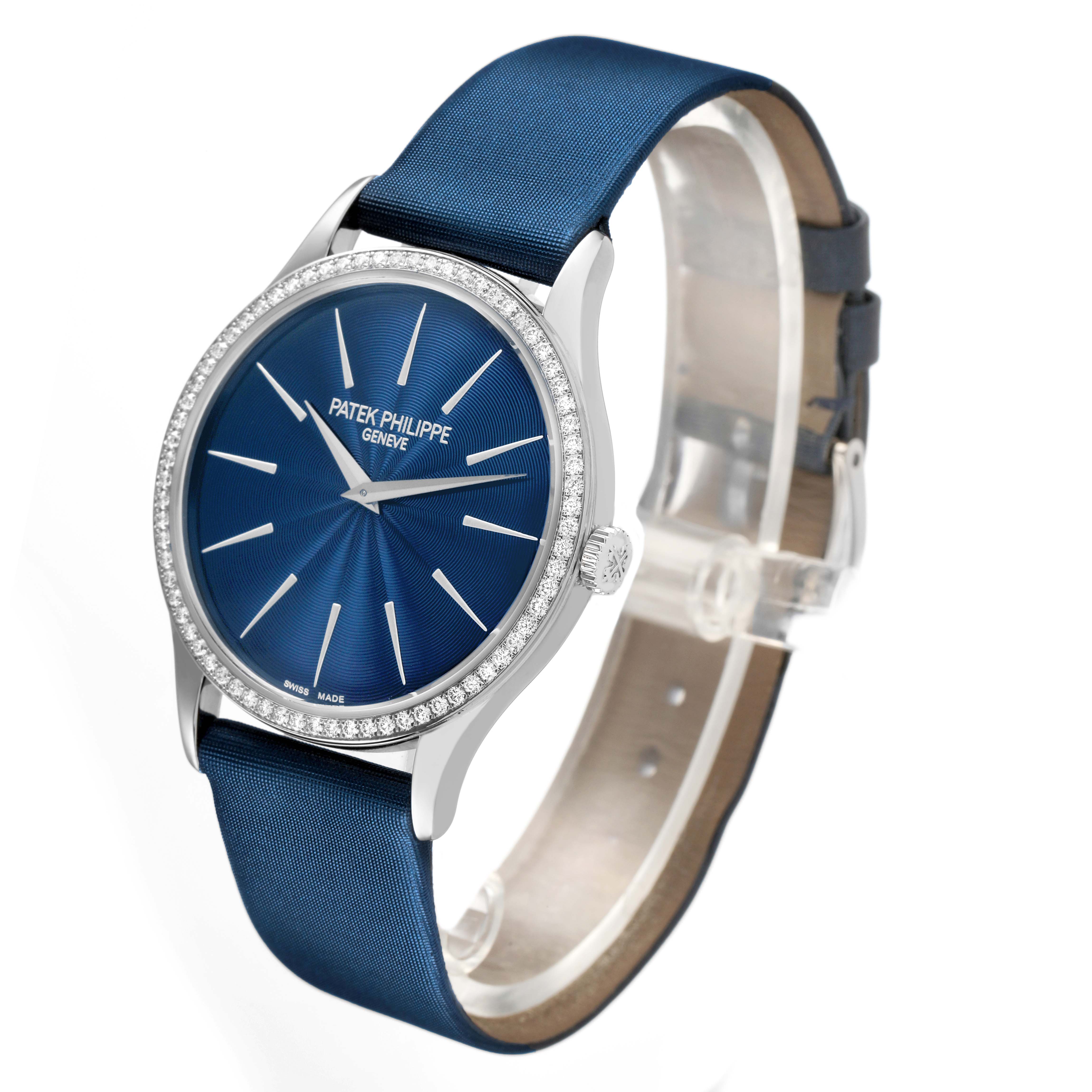 The Patek Philippe Calatrava 4897G-001 Women's White Gold Blue Dial watch is shown at a slight angle, highlighting the blue dial, bezel, and leather strap.
