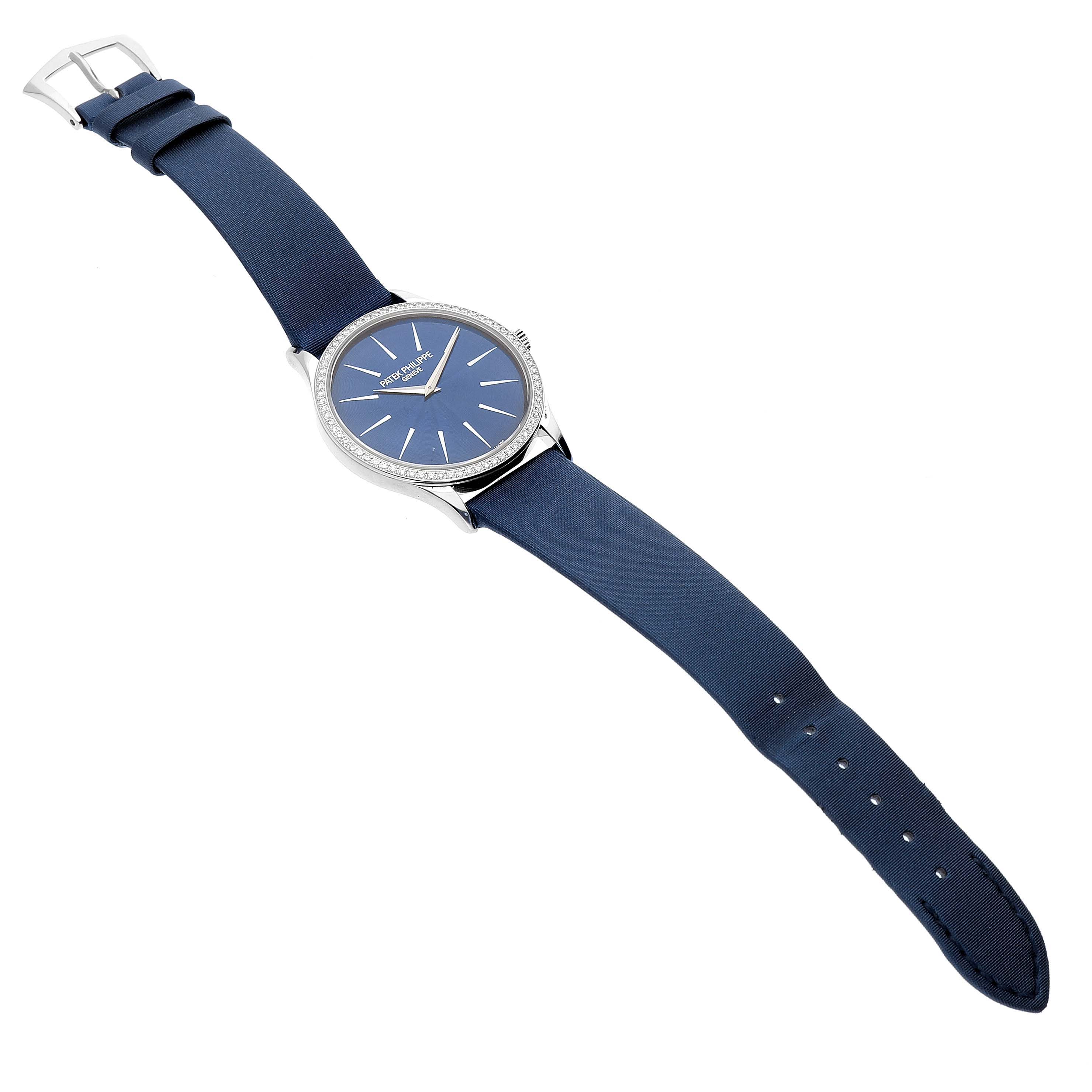 The Patek Philippe Calatrava 4897G-001 Women's White Gold Blue Dial watch is shown at a slightly elevated side angle, displaying the face, bezel, and full strap.