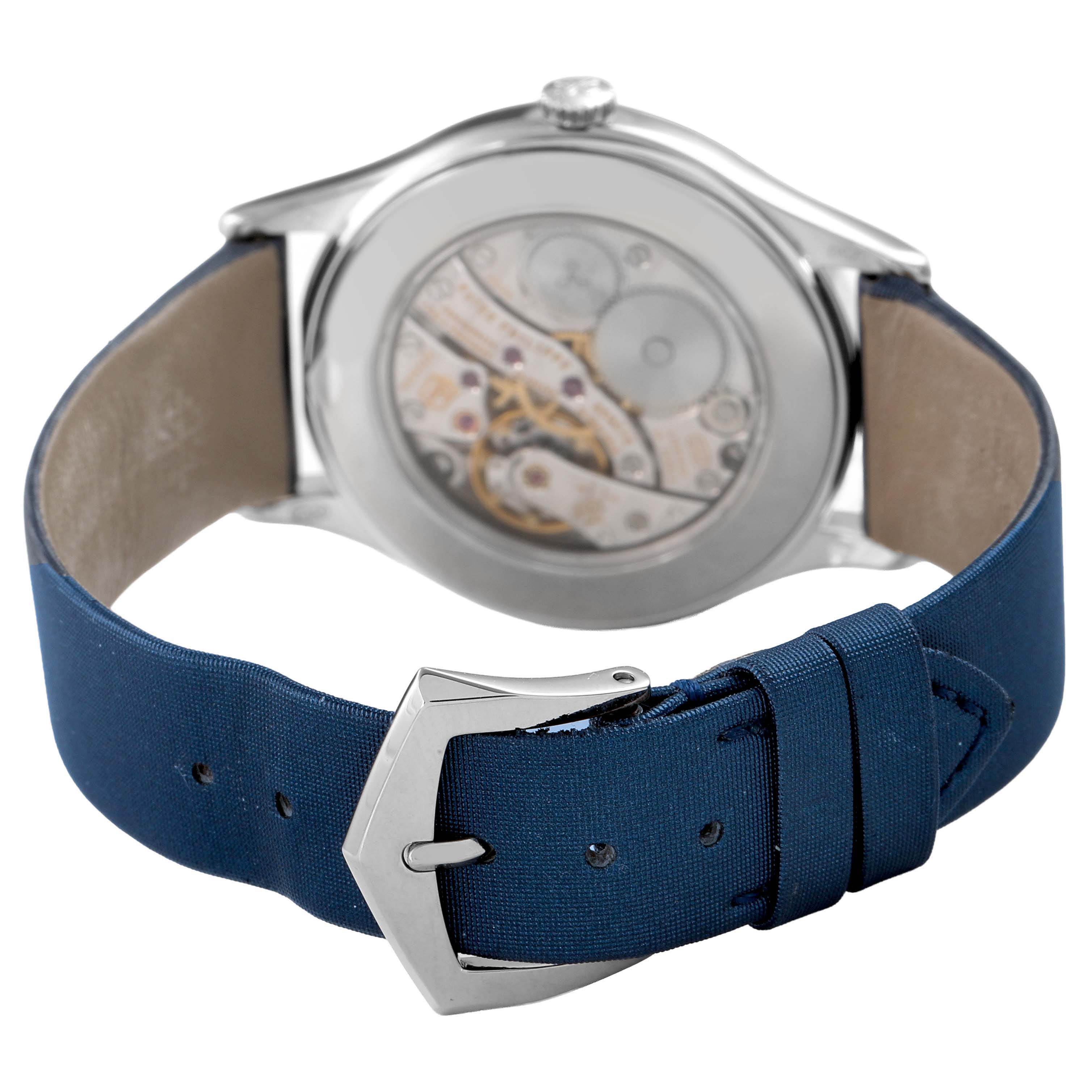 The image shows the back view of a Patek Philippe Calatrava 4897G-001 Women's White Gold Blue Dial, highlighting the movement and navy strap with buckle.