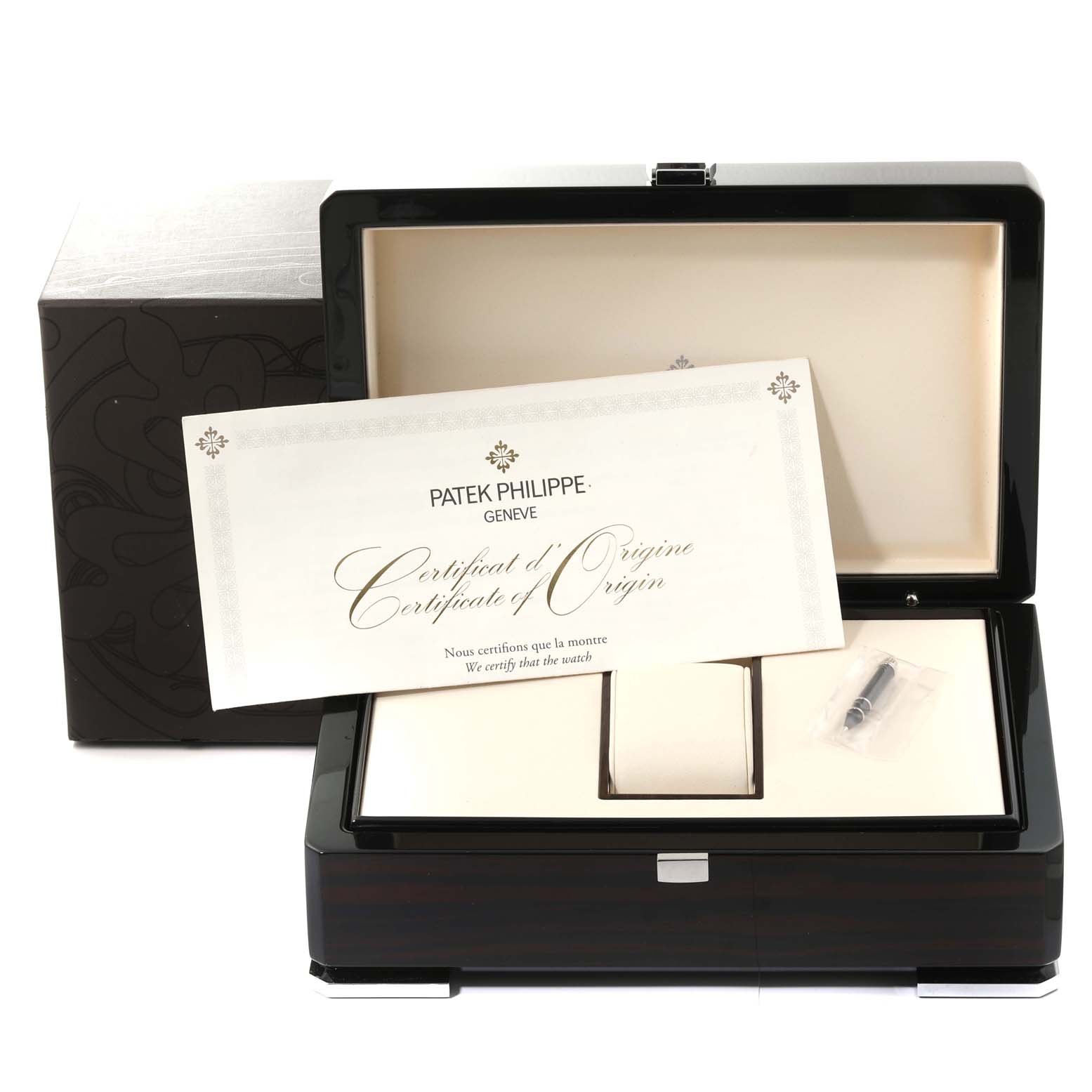 This image shows the Patek Philippe Calatrava 5524G-001 Men's White Gold Black Dial 5524G-001 Men's White Gold Black Dial's empty watch box, certificate of origin, and an accessory item from a front angle.