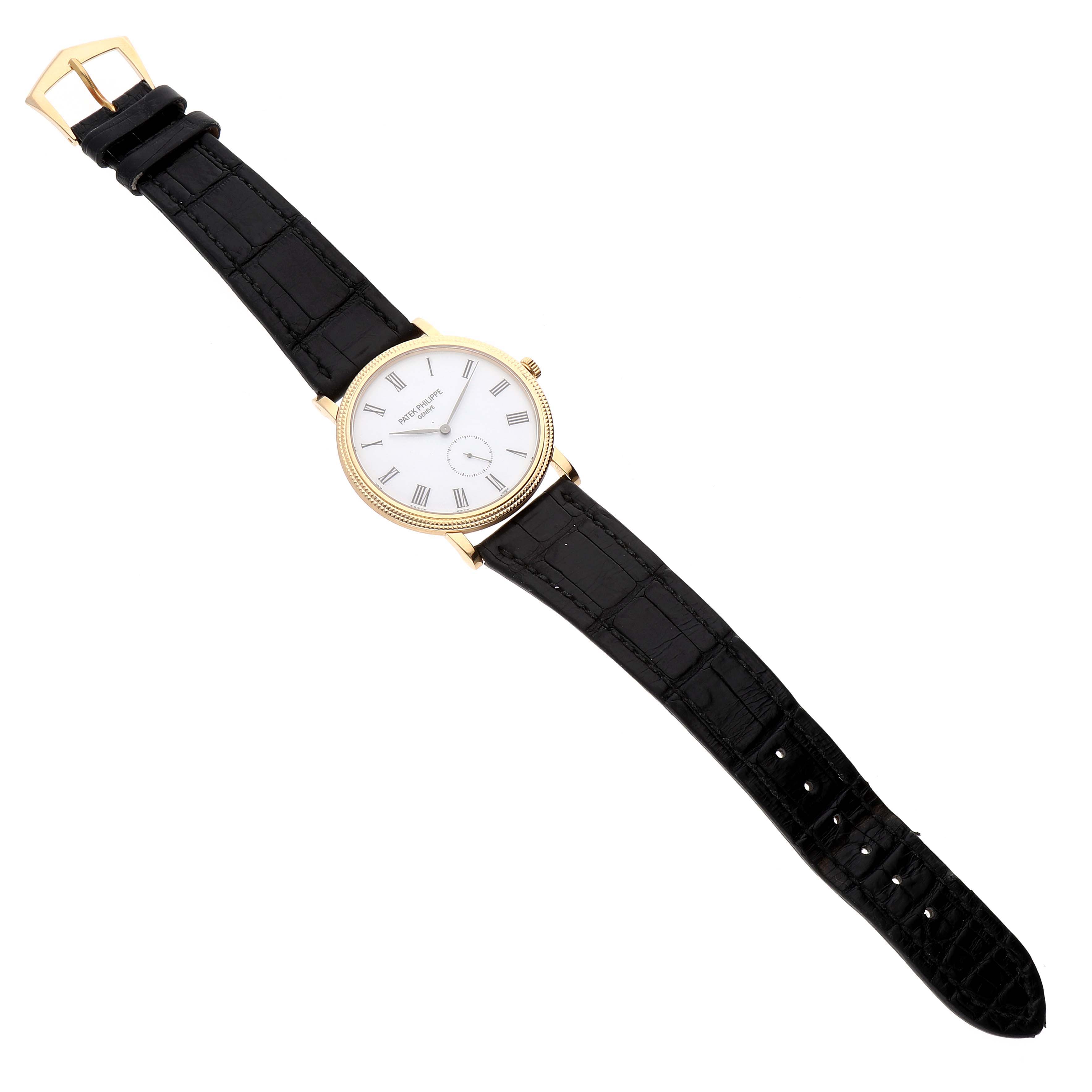 The image shows a Patek Philippe Calatrava 5119J Men
s White Gold White Dial 5119J Men
s White Gold White Dial watch at a top-down angle, displaying the entire face, strap, and clasp.